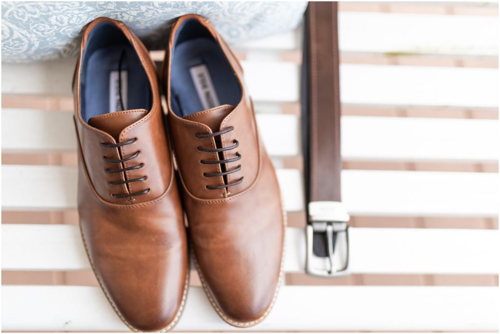 Grooms shoes and belt on a bench for detailed wedding shots
