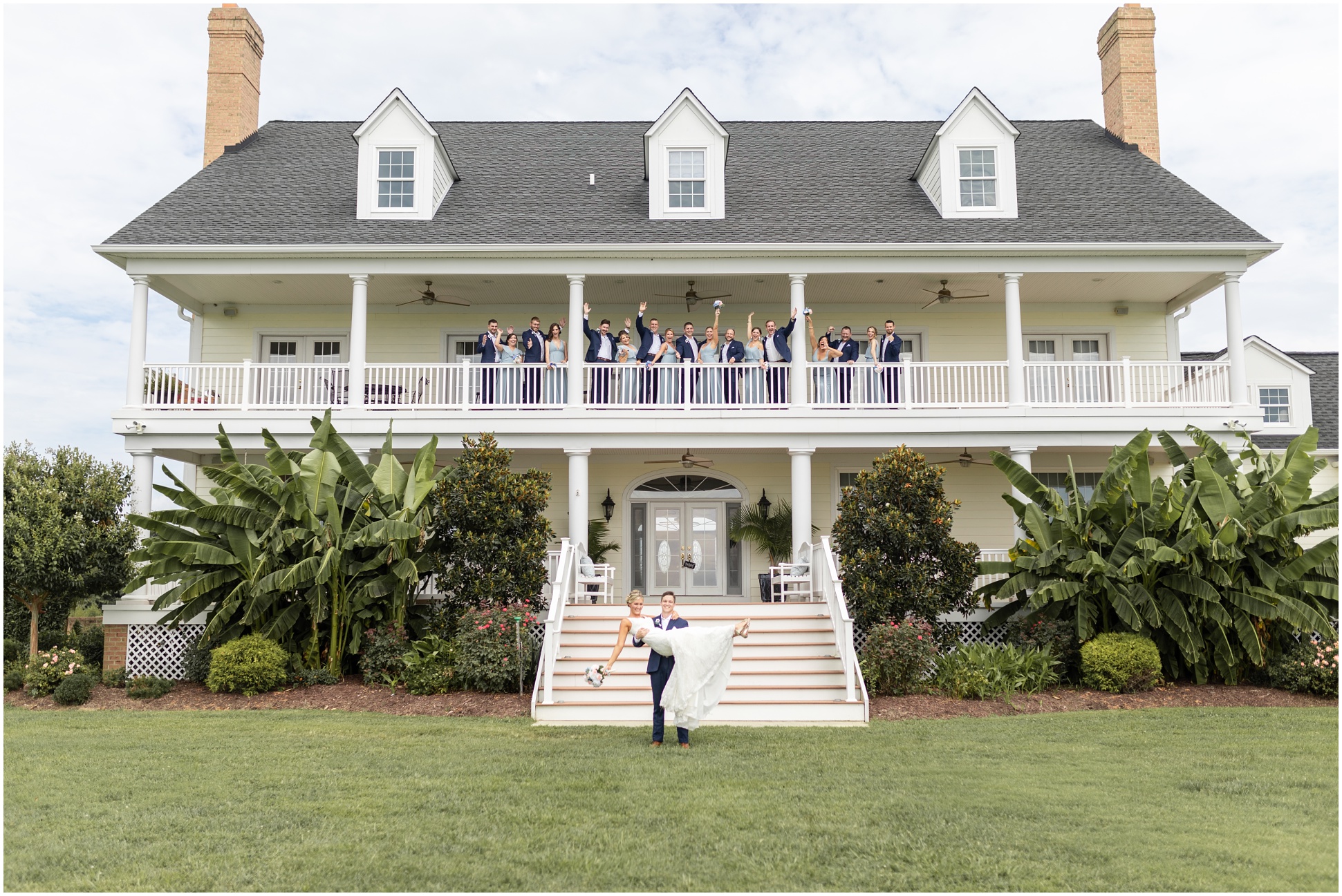 full bridal party up on the second story porch with the bride and groom down bottom! 