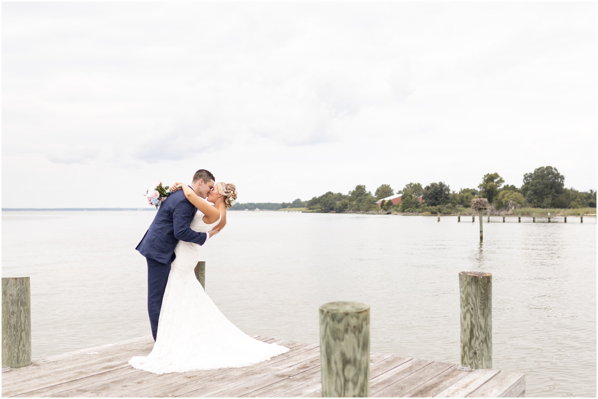 Bride and groom kissing on the dock after the first look