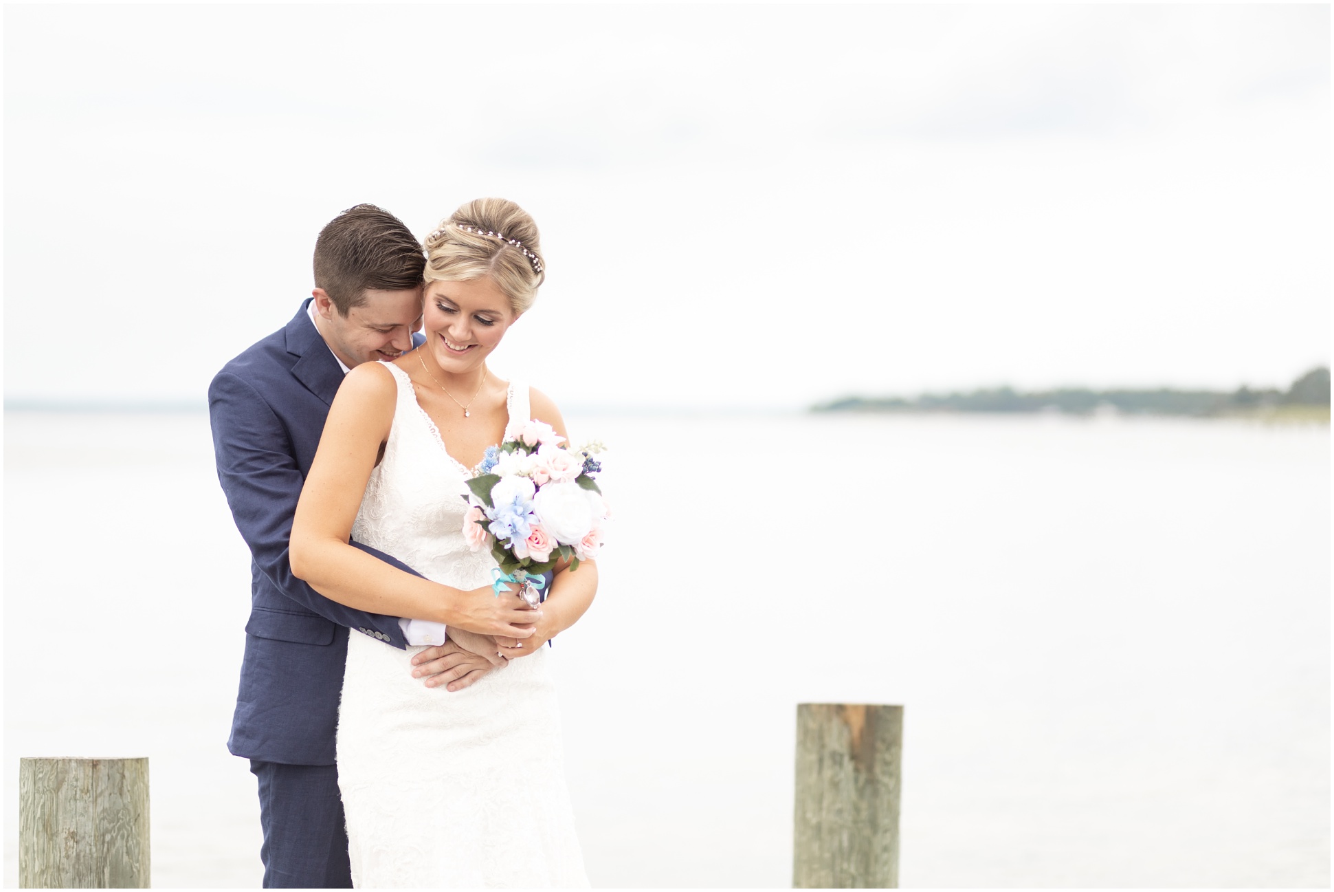 Bride and groom kissing on the dock after the first look