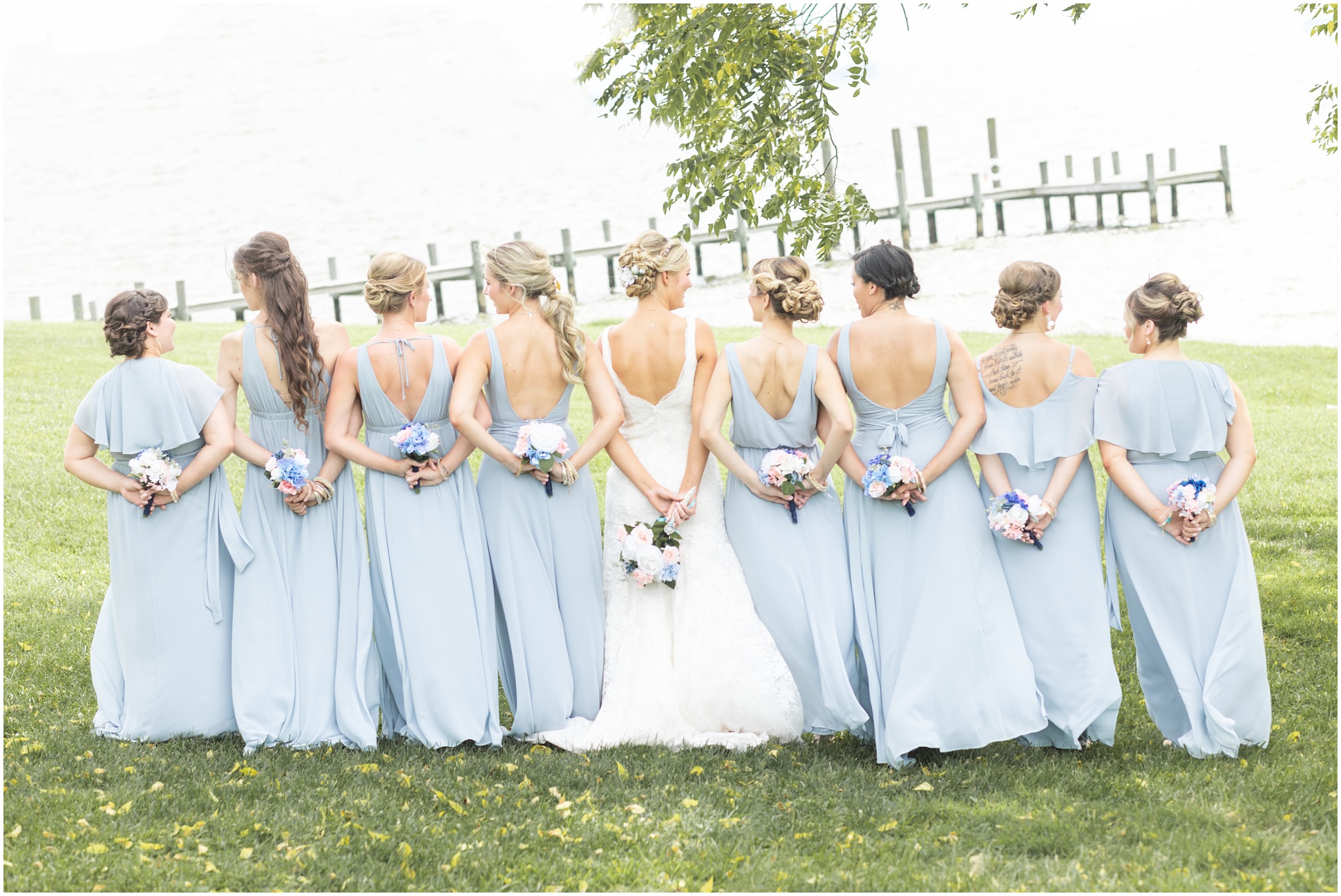 Bride with bridesmaids by the water