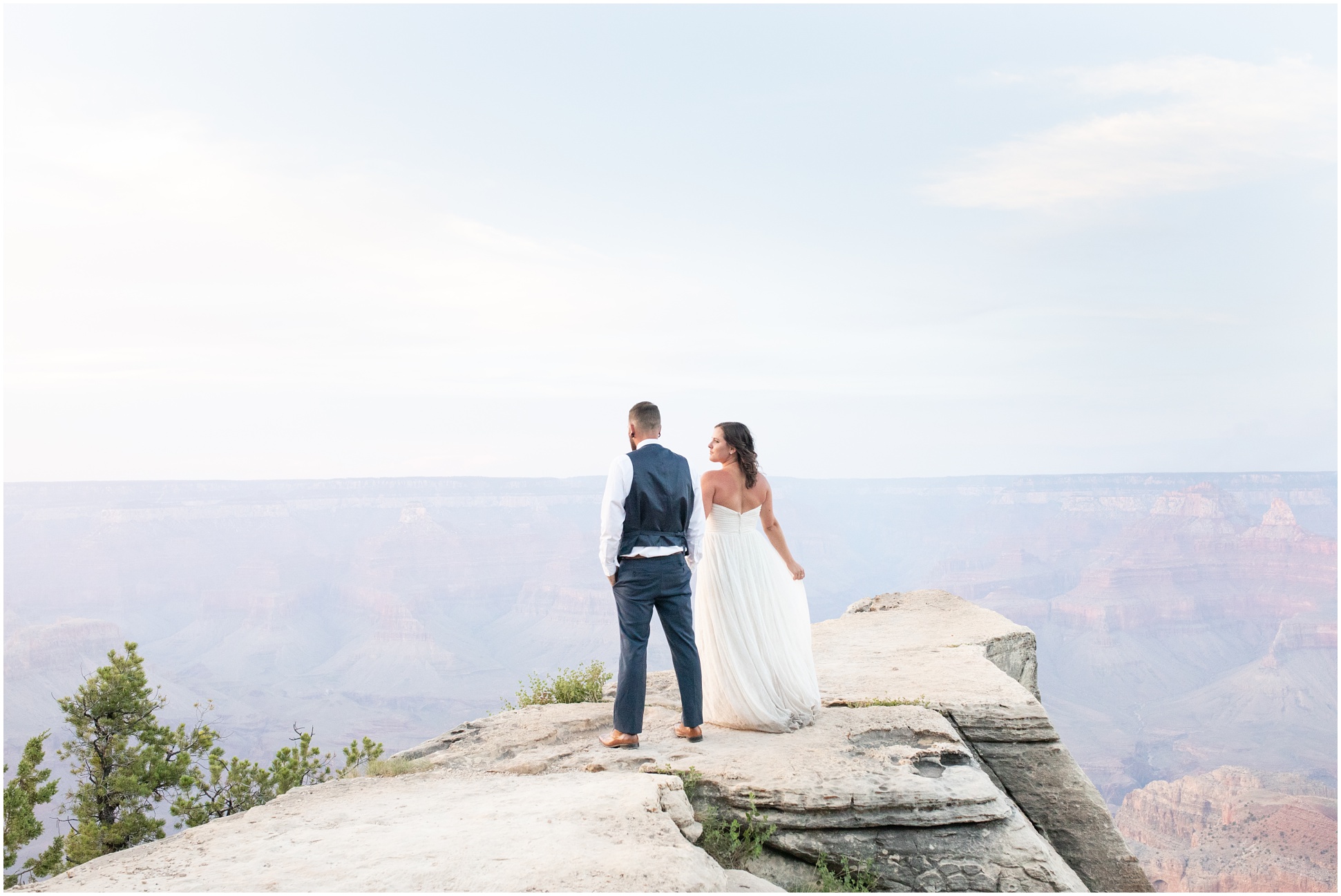 Sunset Wedding Portraits at the Grand Canyon - Bride and Groom standing out on the point of the South Rim 