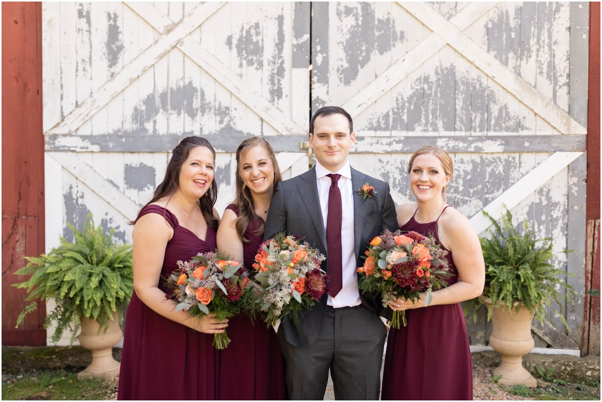 GROOM AND BRIDESMAIDS IN FRONT OF THE BARN