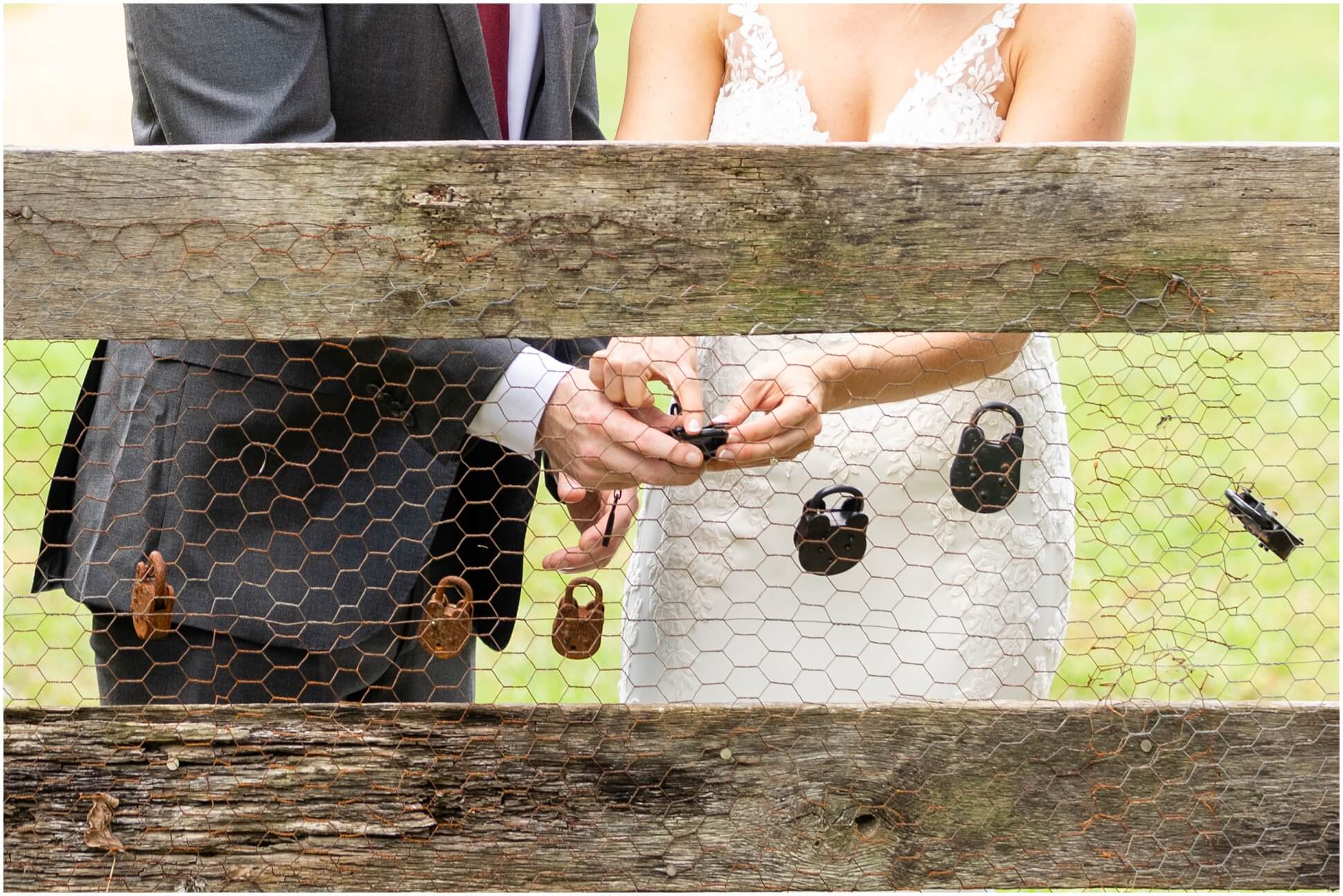BRIDE AND GROOM HANGING THE LOCKET ON THE FENCE AT WINDING CREEK FARM, VIRGINIA