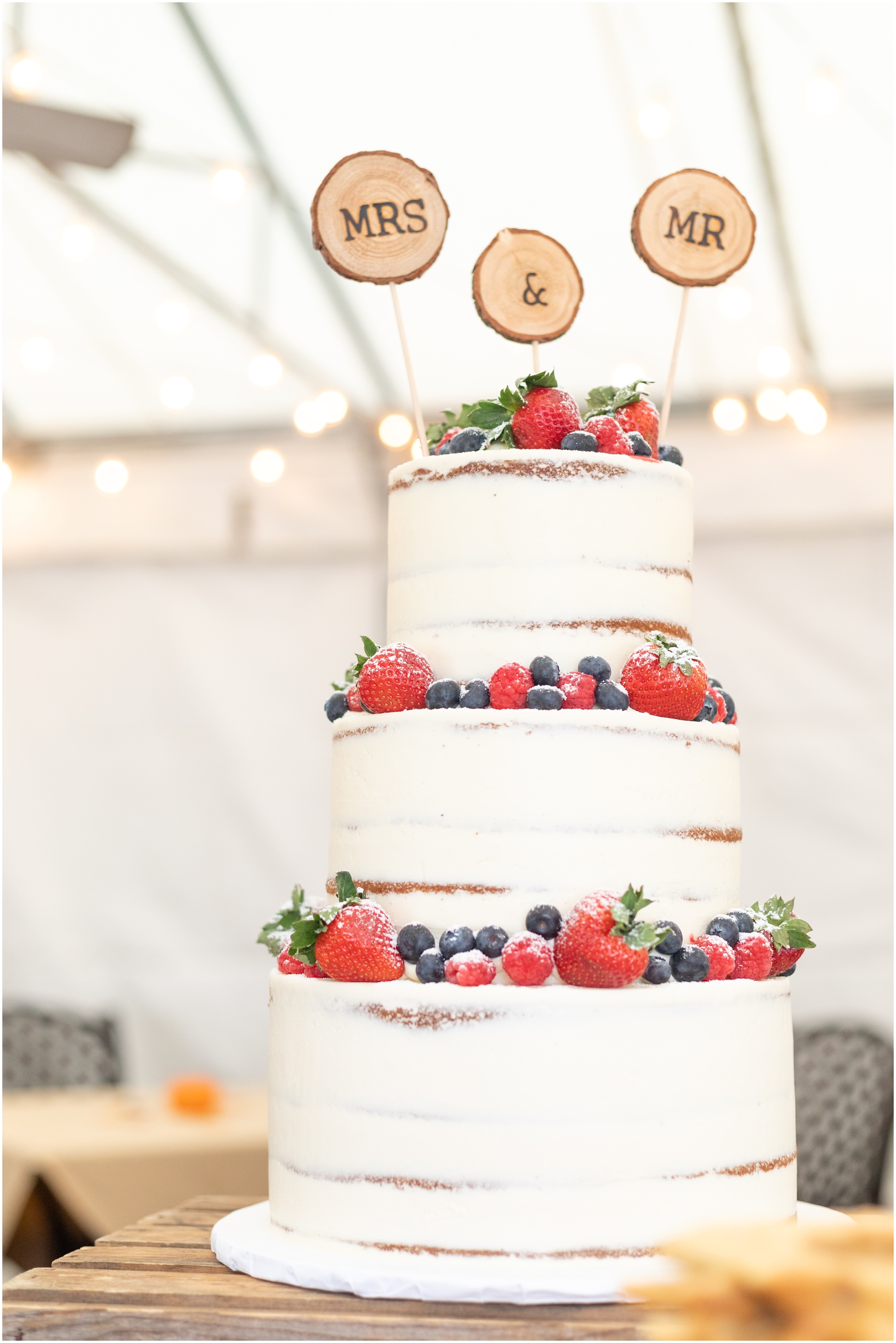 Partial Naked Cake with Fresh Fruits and a Mr. and Mrs. Cake Topper