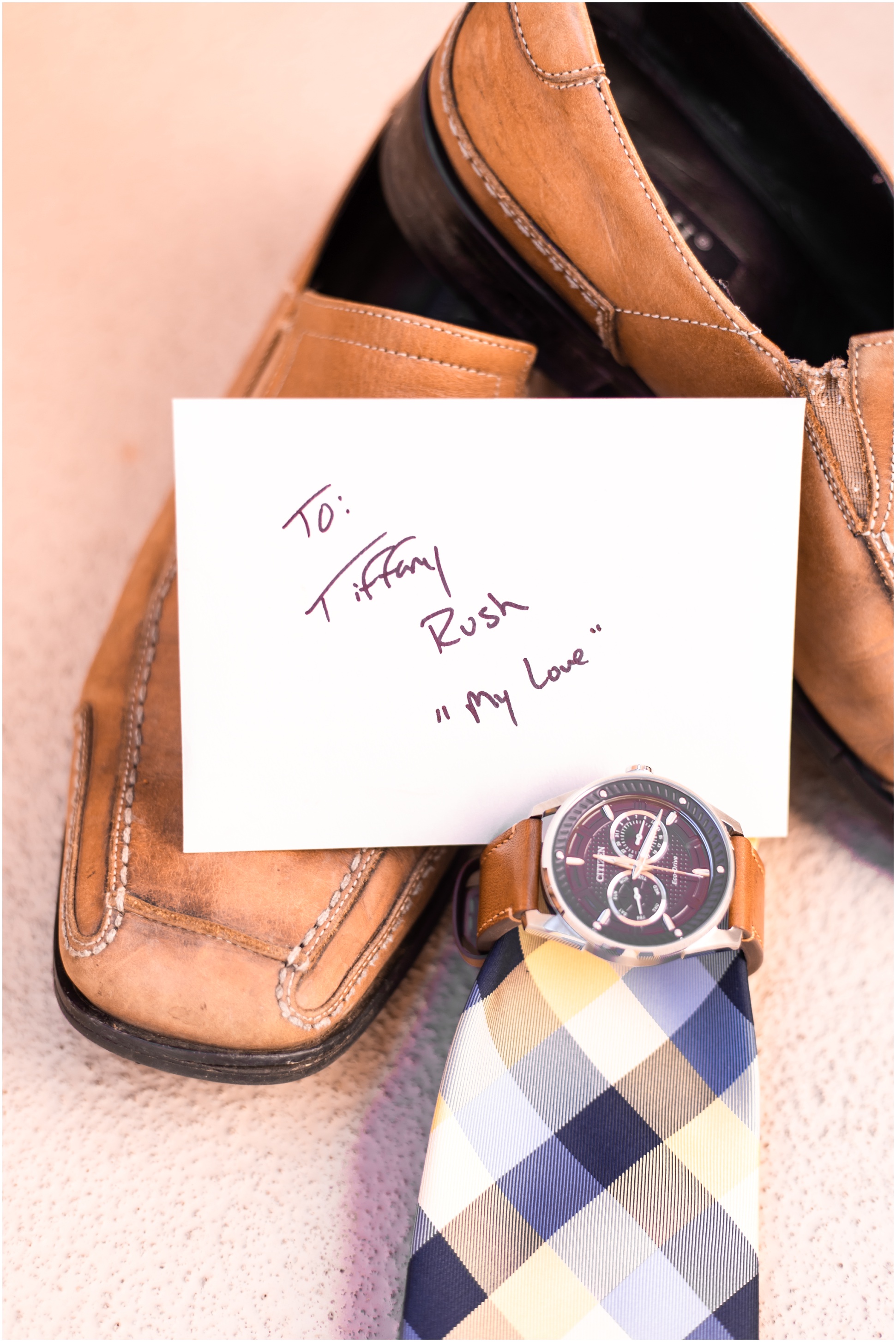 Detail shot of grooms shoes, watch, plaid tie, and the note to his love