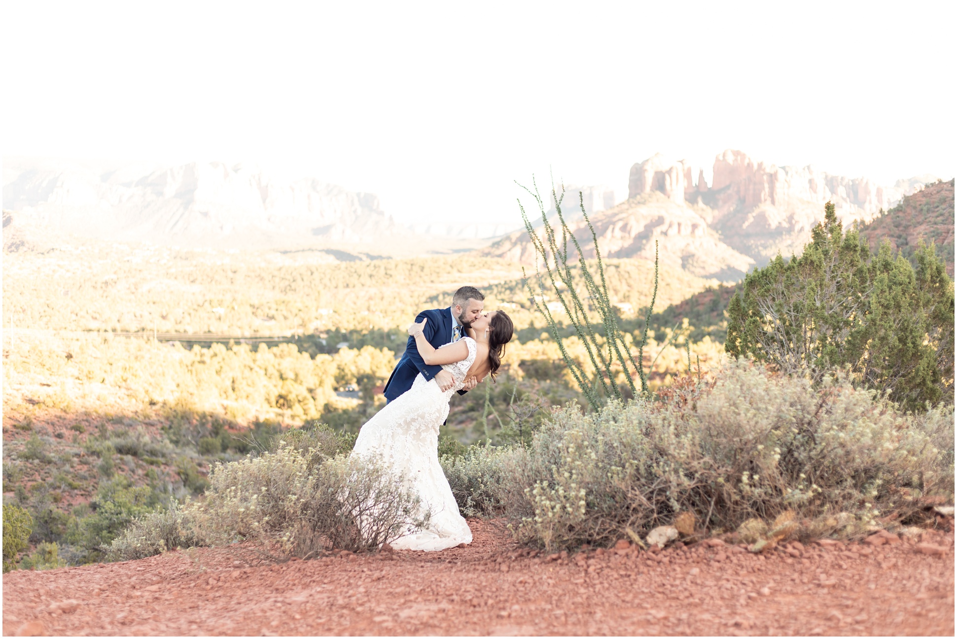 Bride and Groom Portrait for Tiffany and Anthony in Sedona. Bride wearing long white lace wedding gown, groom wearing blue suit with yellow and blue plaid tie.