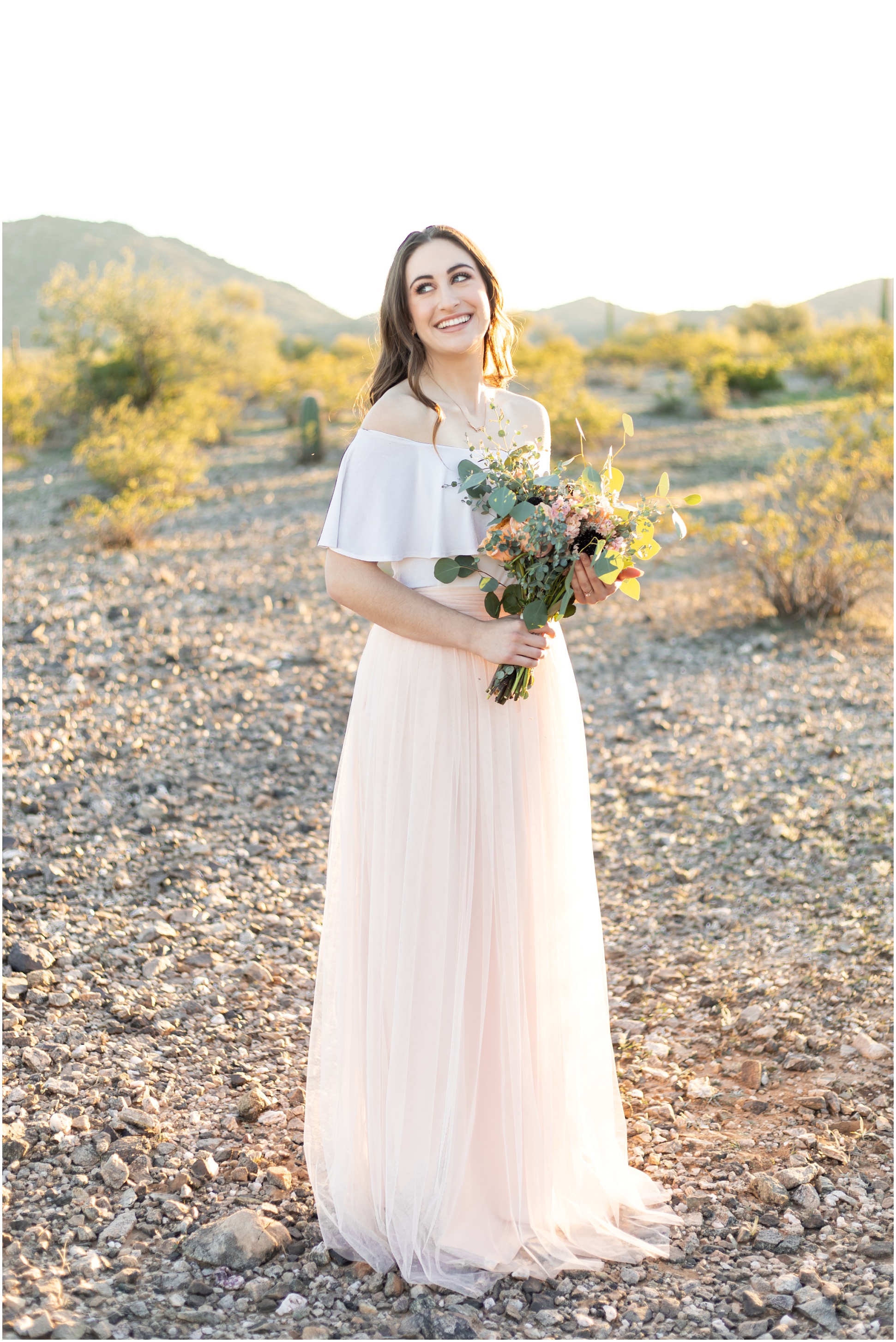 Bride smiling with bouquet in her hand