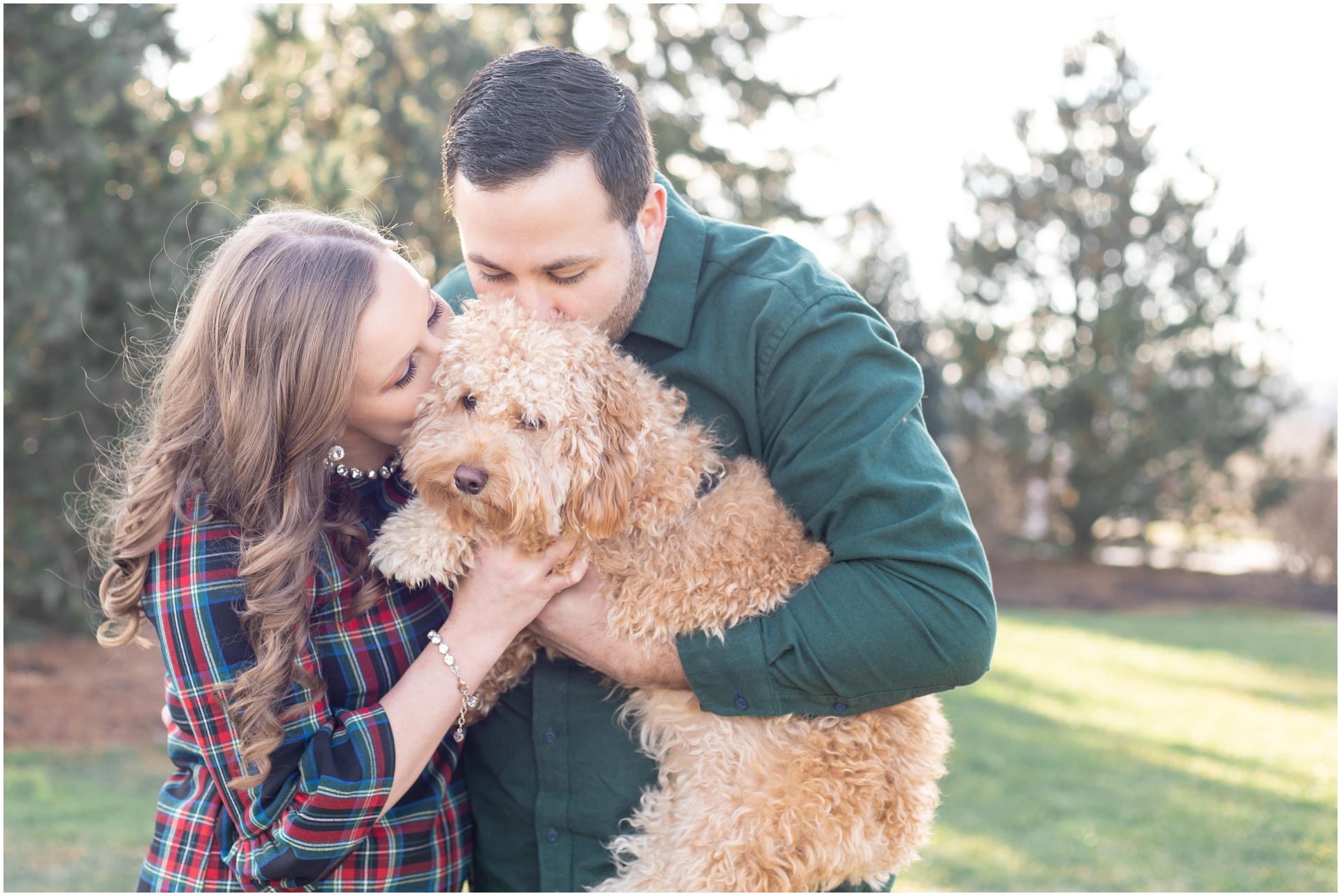 fur parents kissing their puppy during their engagement session
