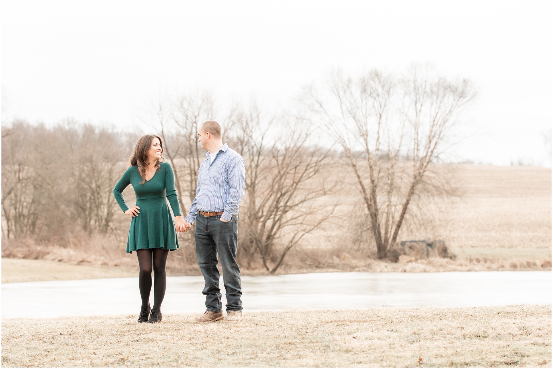 Valerie and Ryan standing by the pond on a cold winter day