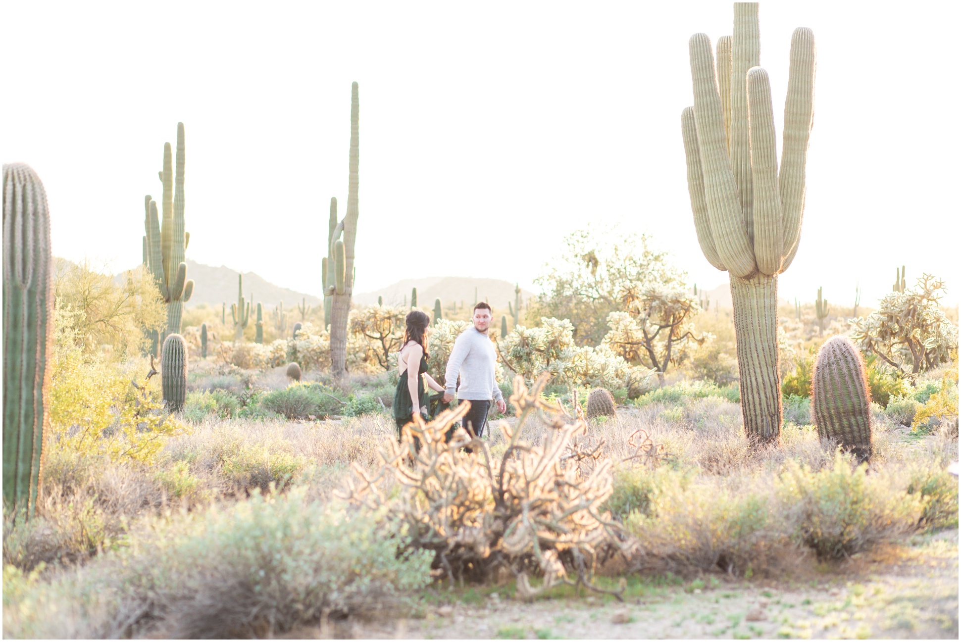 Kaila and Jake walking past saguaro