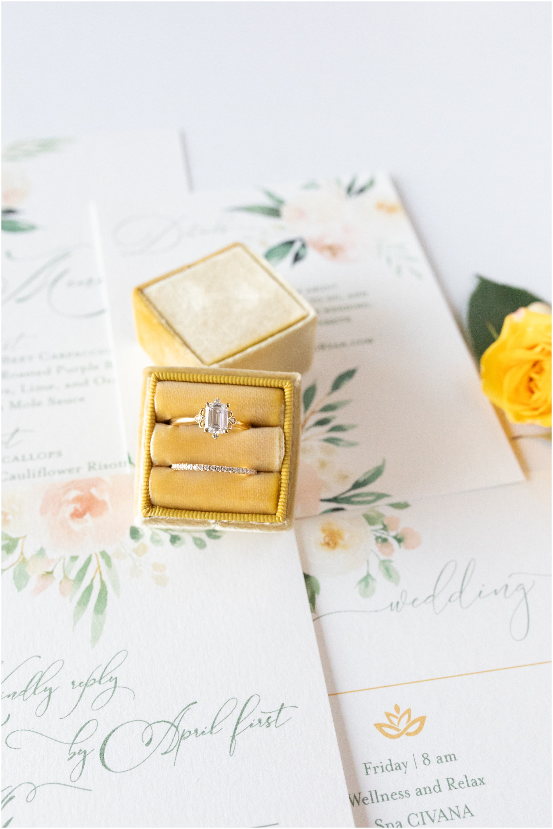 Mustard Gold Mrs. Box with oval diamond ring on top of beautiful invitation suite