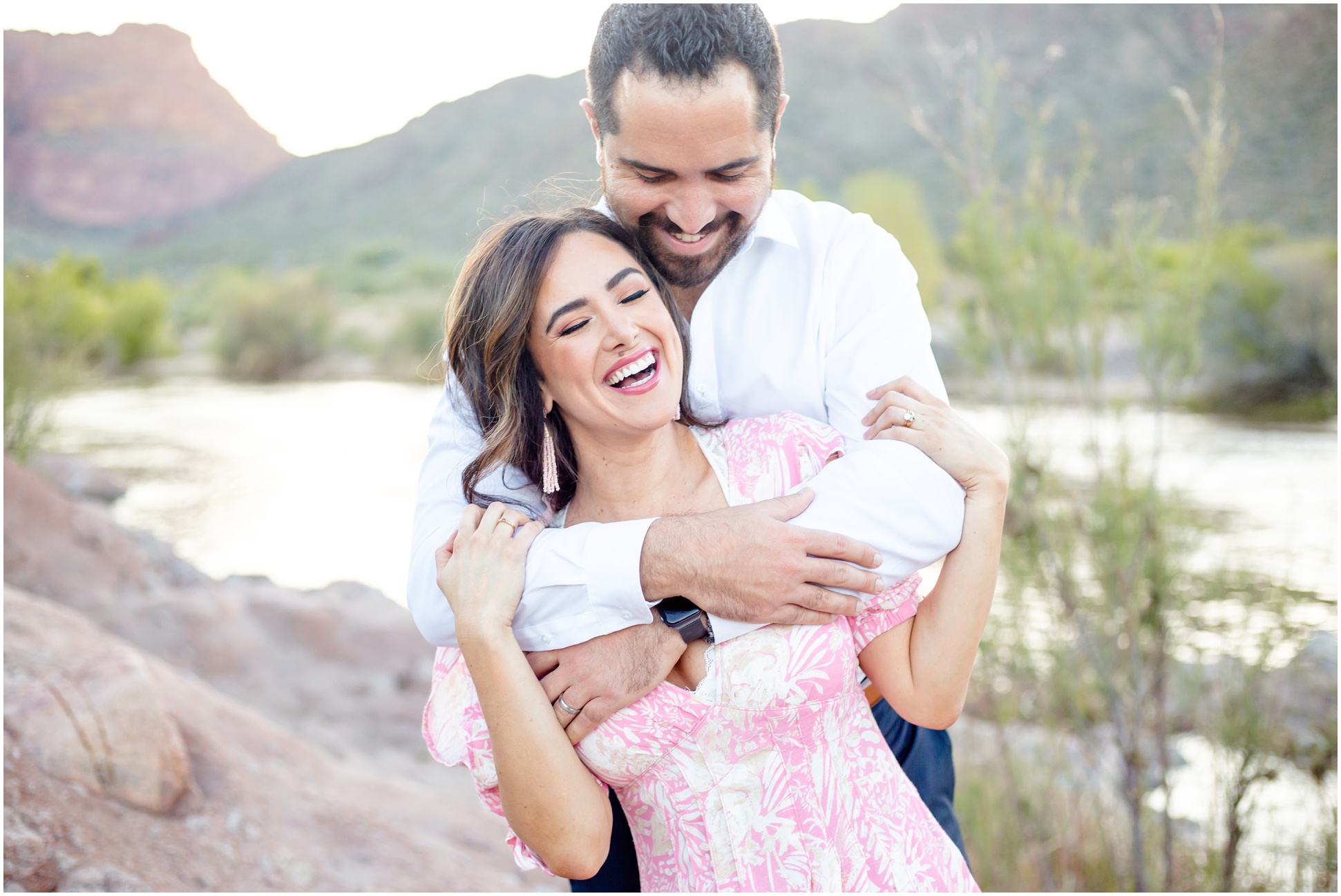 Paul holds on tightly to Anette from behind and rocks her side to side until she giggles