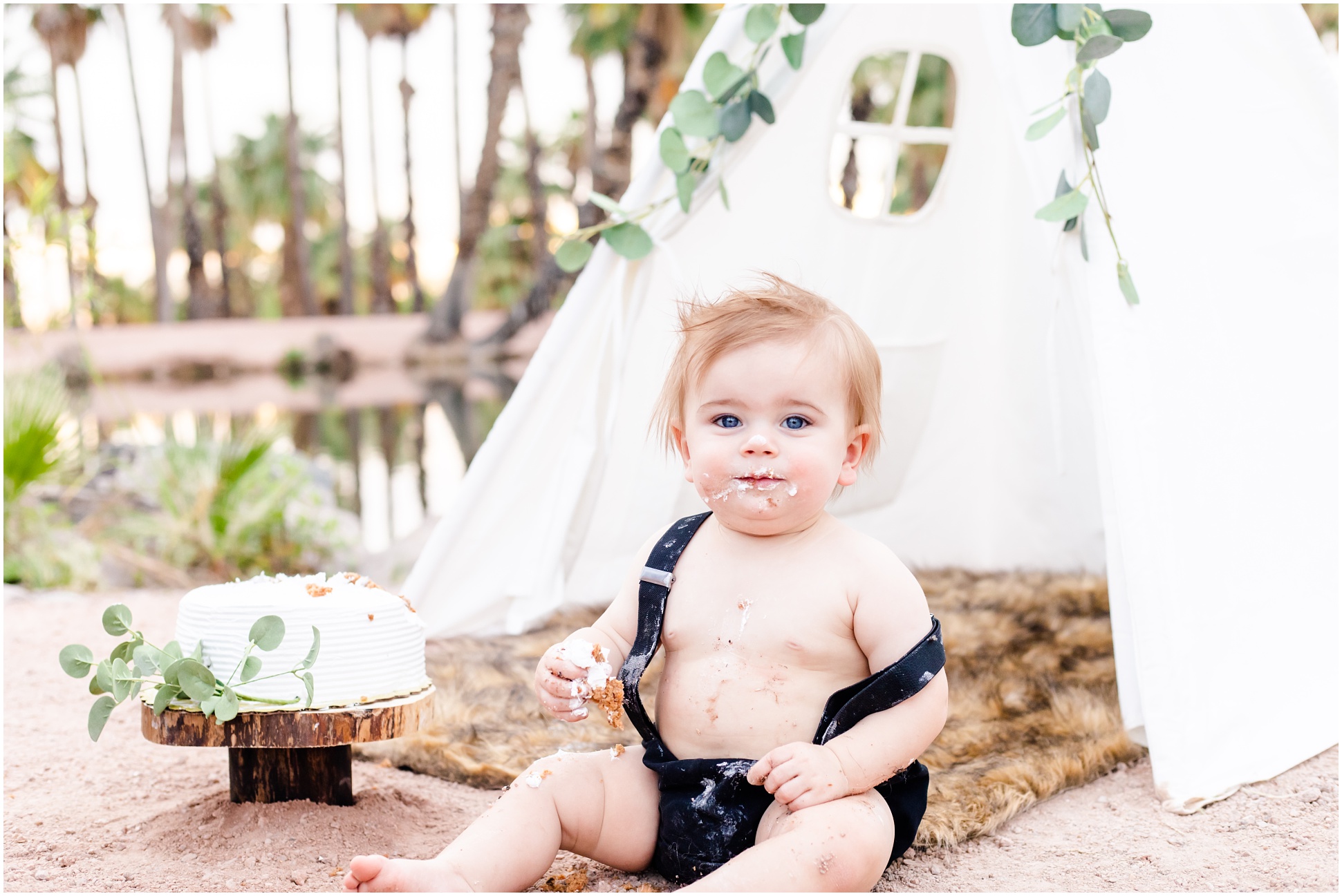 One Year old wearing black diaper cover and suspenders