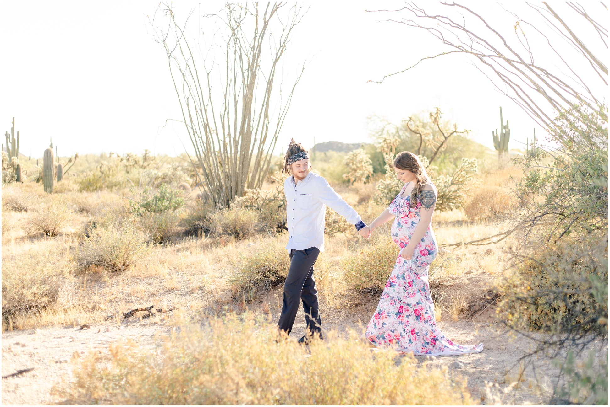 Daniel guiding Miranda and her pregnant belly through the desert for a stroll