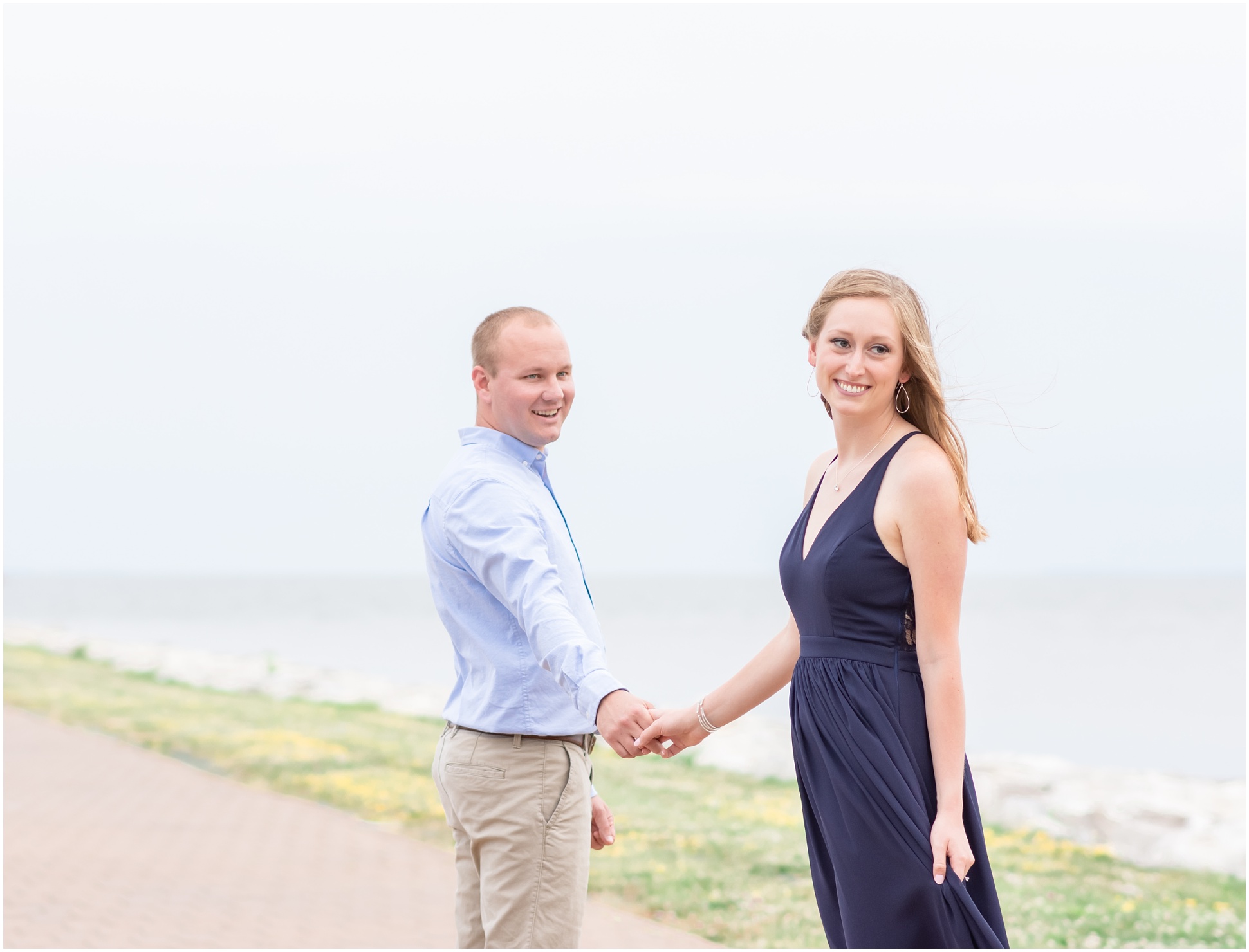 Bride leading groom down the pier, away from the water