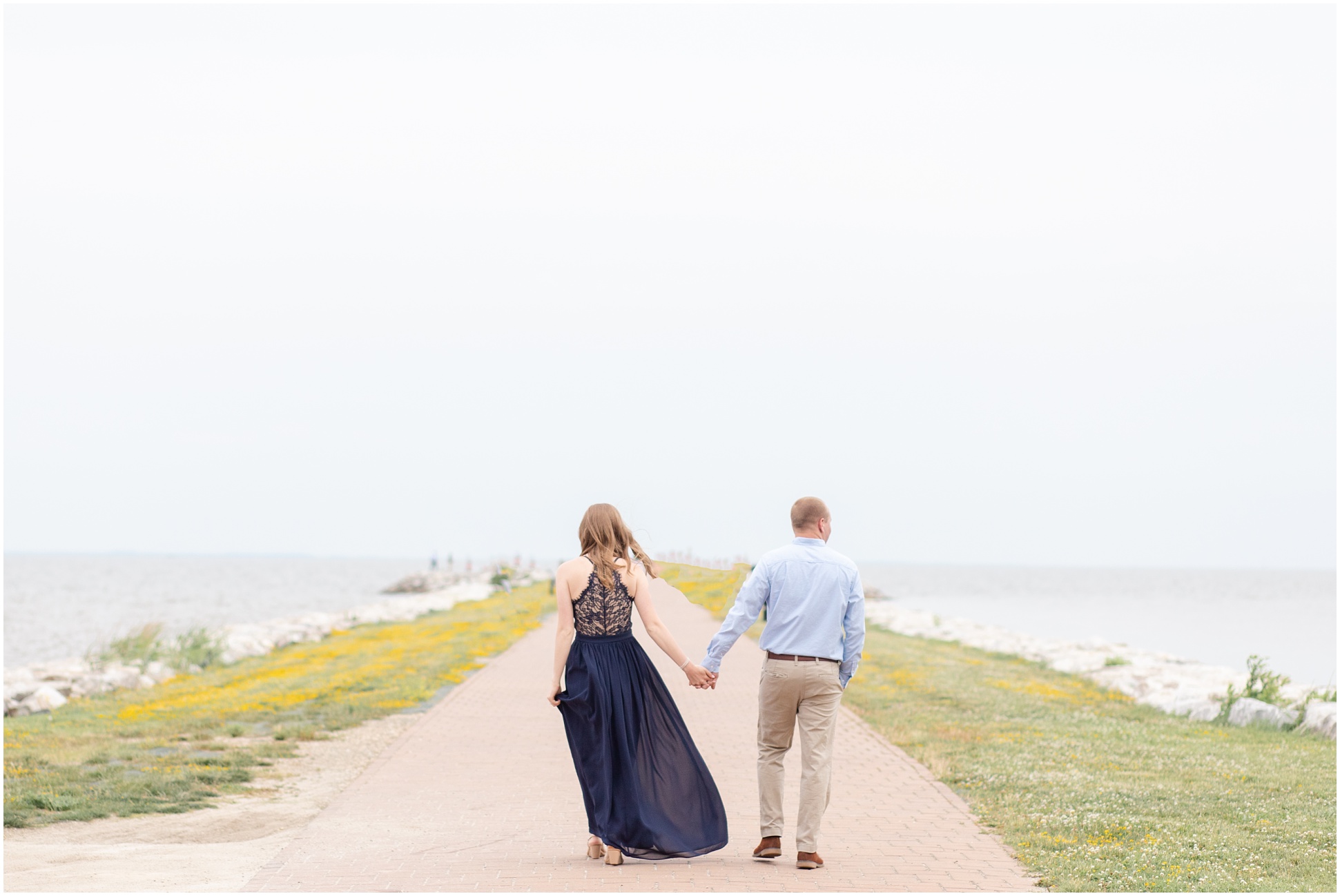 Bride-To-Be Wearing Long Navy Dress Walking Hand-in-hand with her fiance