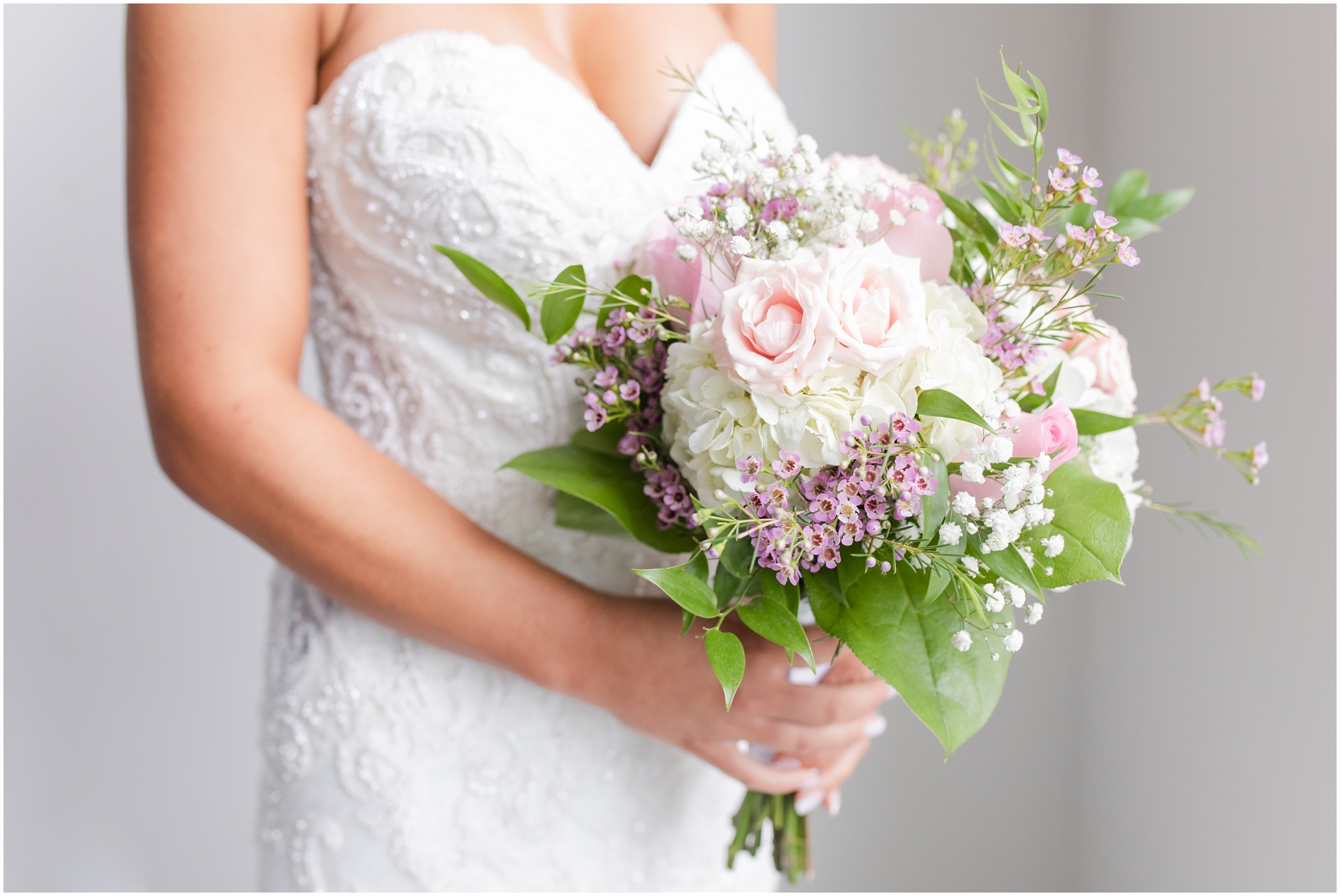 Bride holding floral bouquet on wedding day