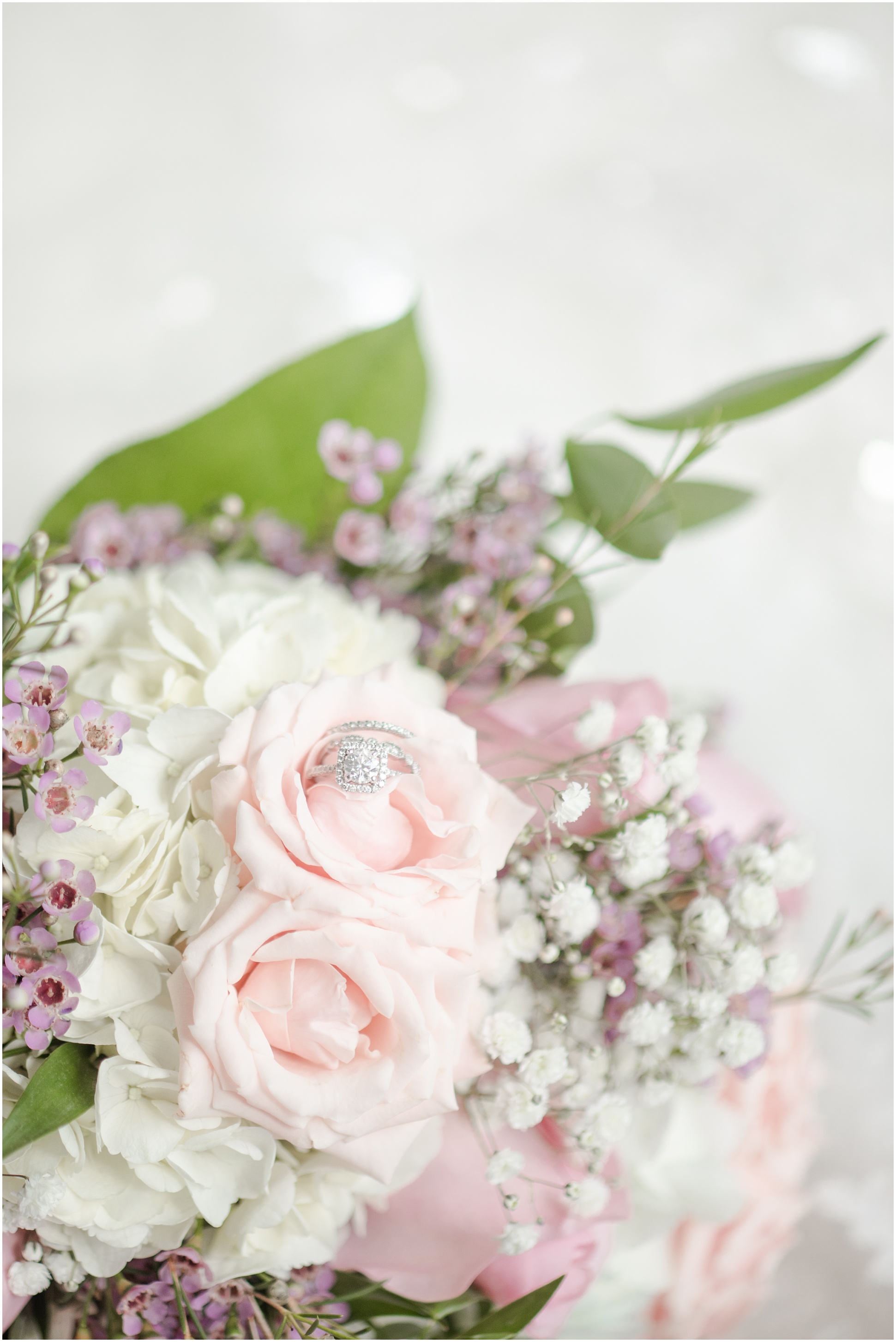 The rings in a blush floral bouquet
