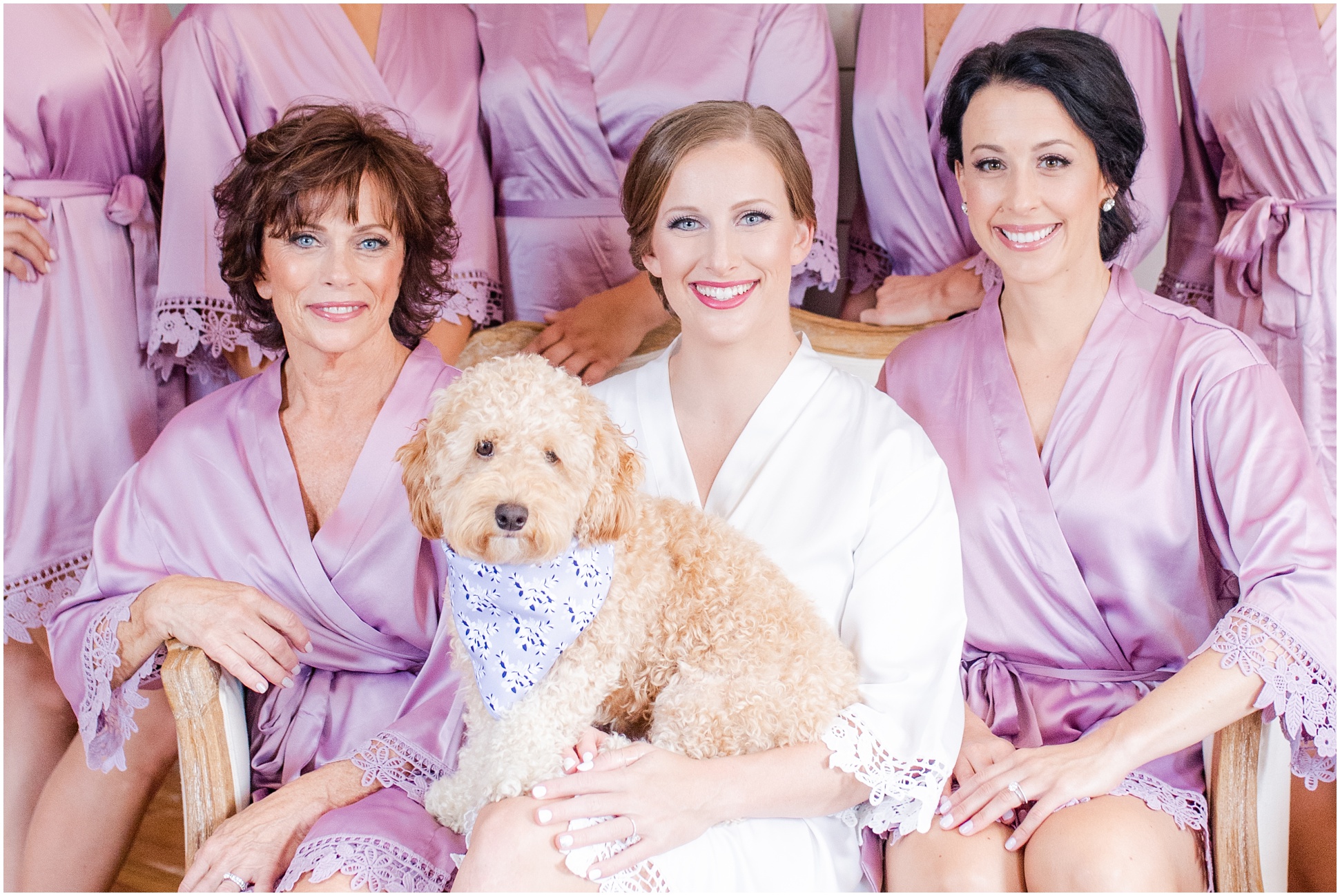 Bride, puppy, and bridal party in purple robes