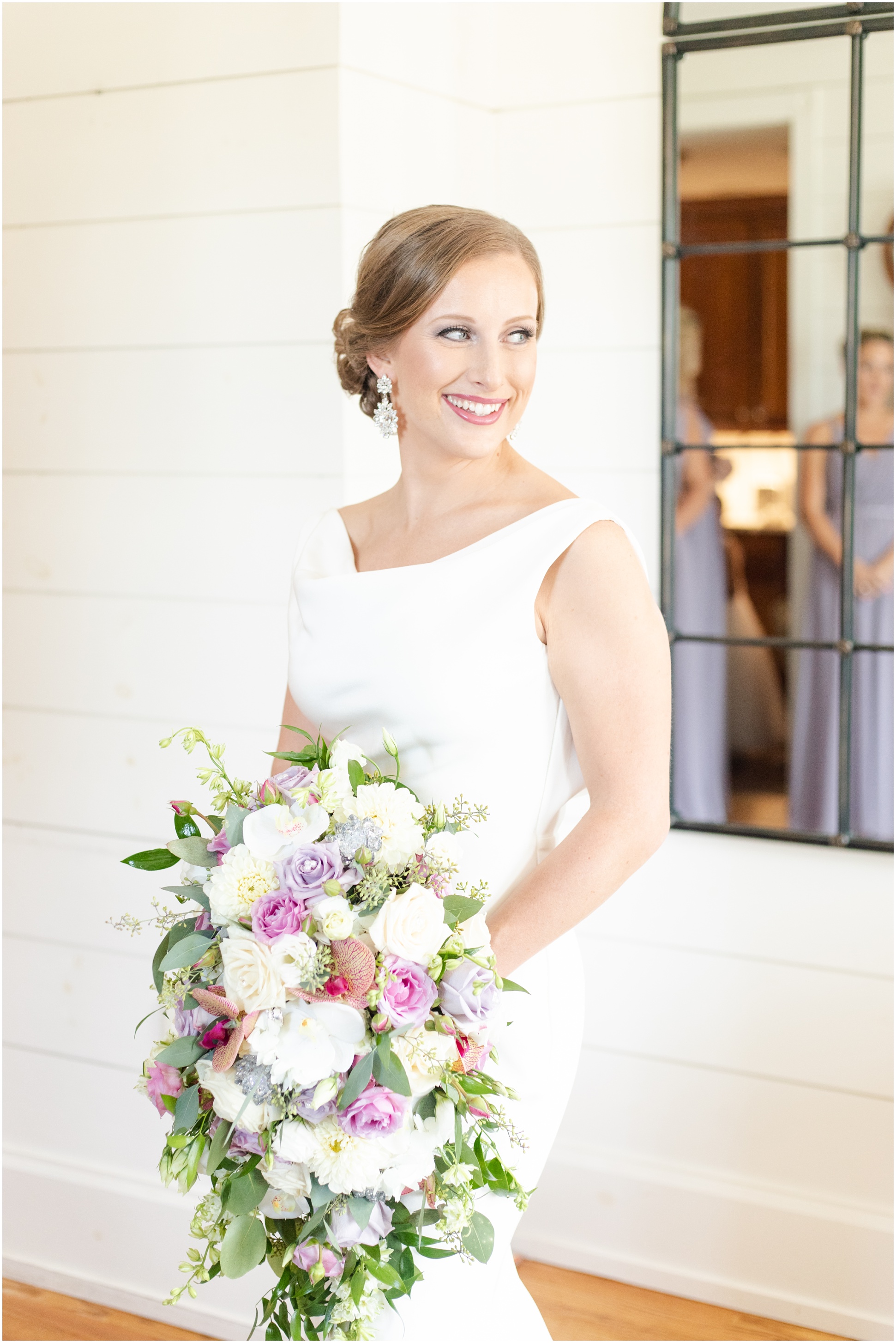 Bride holding pink, purple, and white bouquet