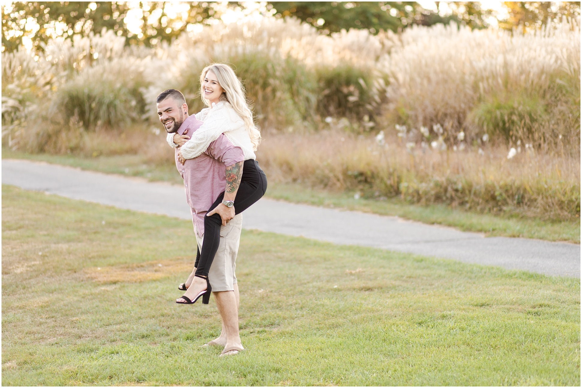 Engaged man giving his fiance a piggy back ride