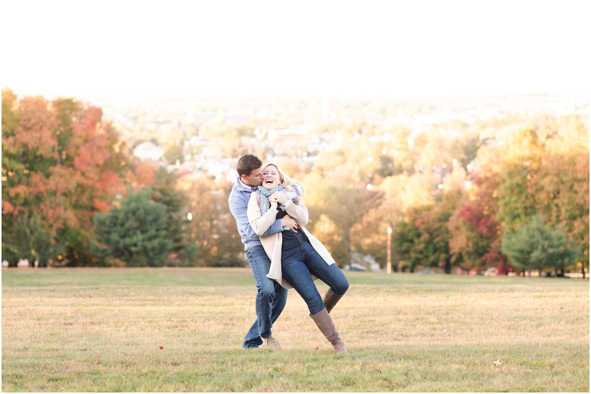 Couple twirling in open field during autumn