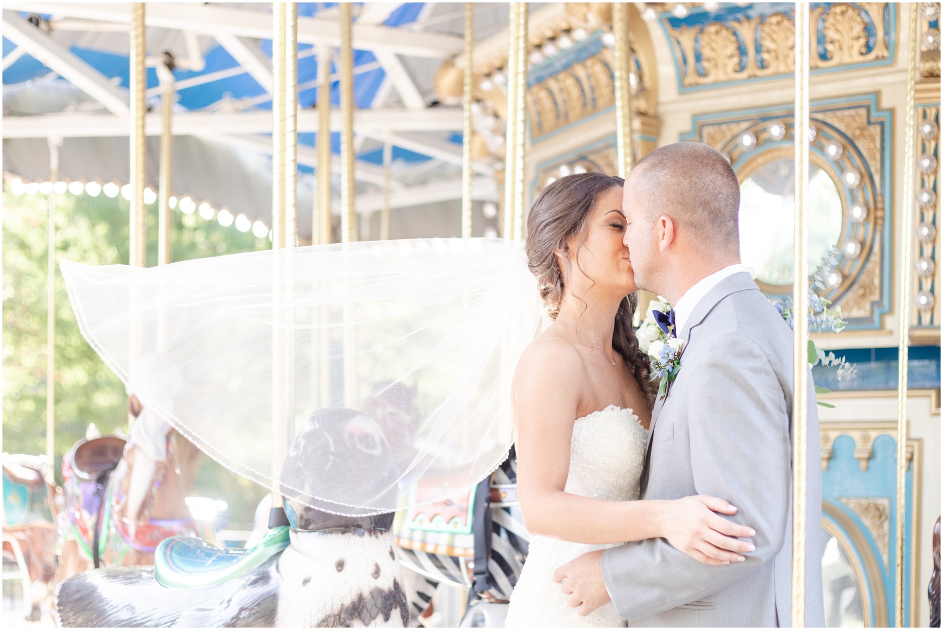 Married Couple kissing on the carousel at the Maryland Zoo