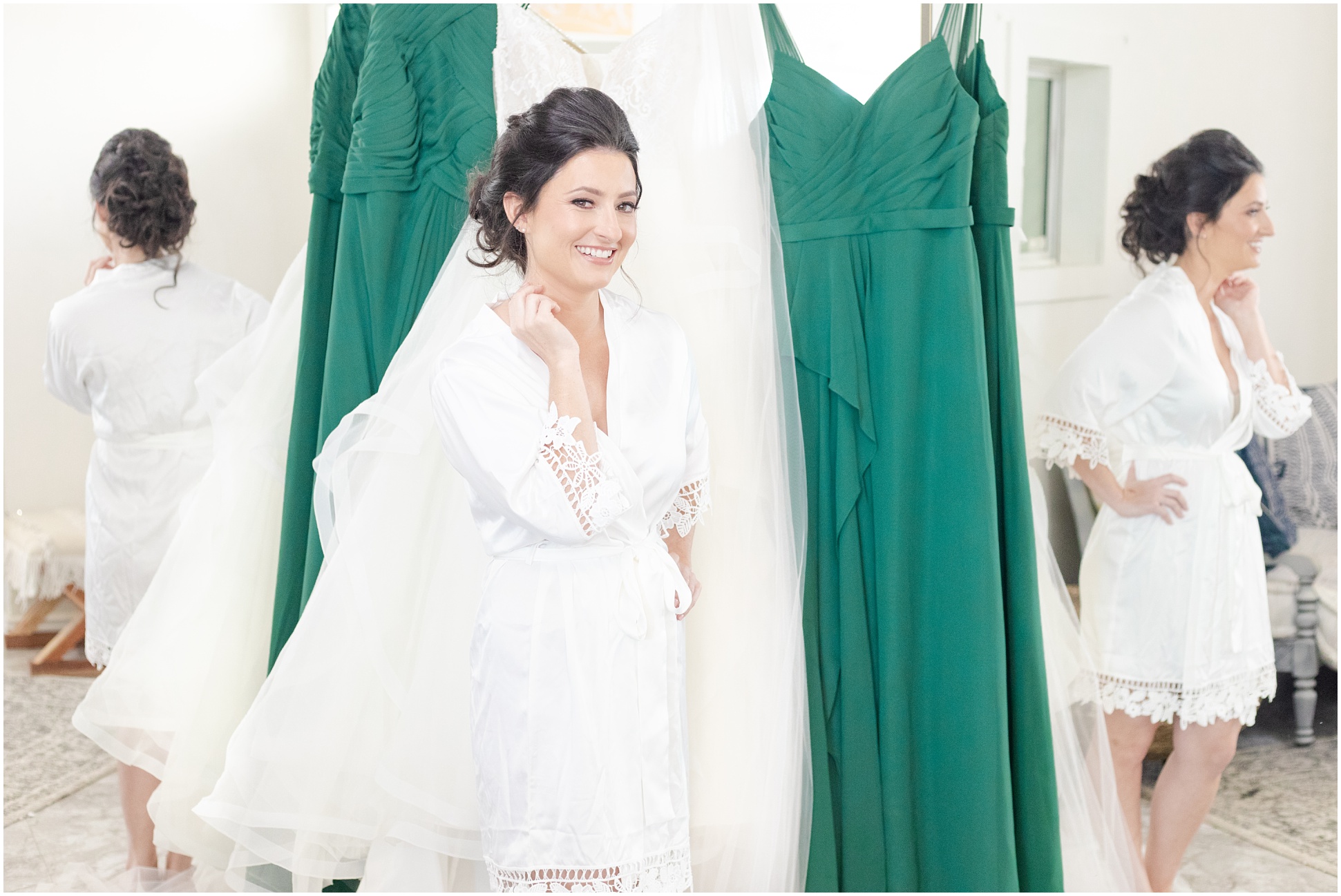 bride standing in front of wedding dress framed by bridesmaids green dresses 