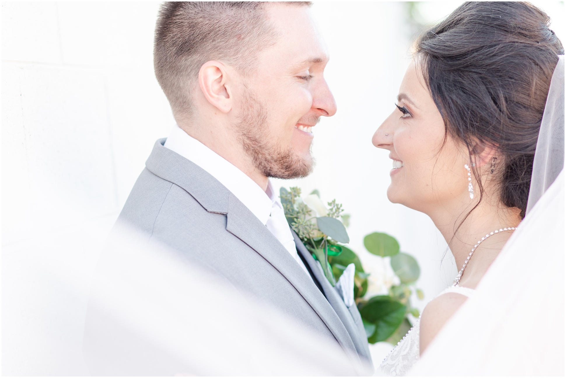 Close up of Bride and Groom smiling at each other 
