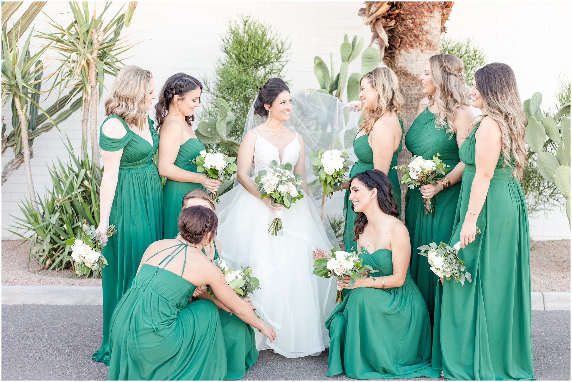 Group photo of bridesmaids touching up bride