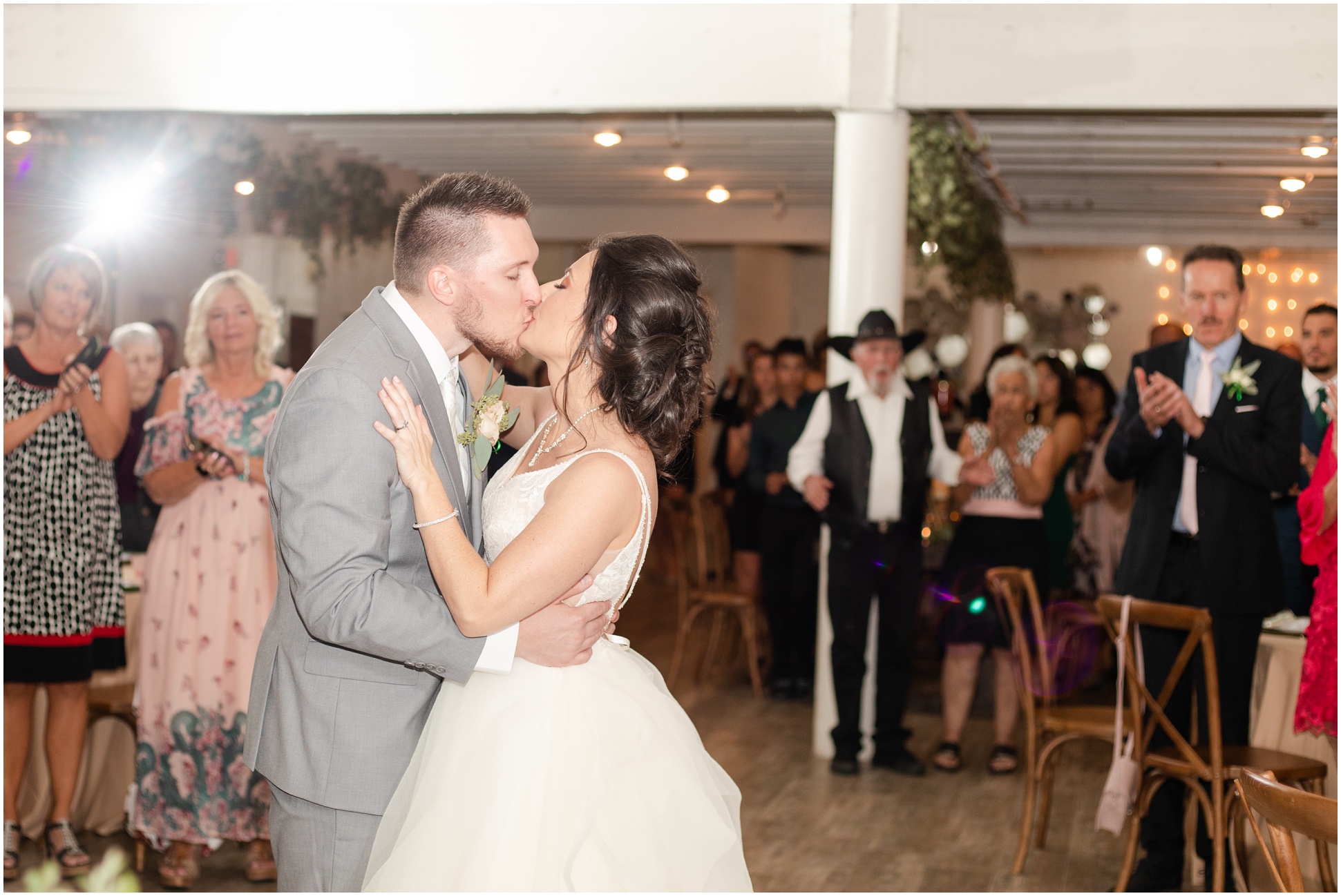 Bride and Groom kissing on dance floor at the reception 
