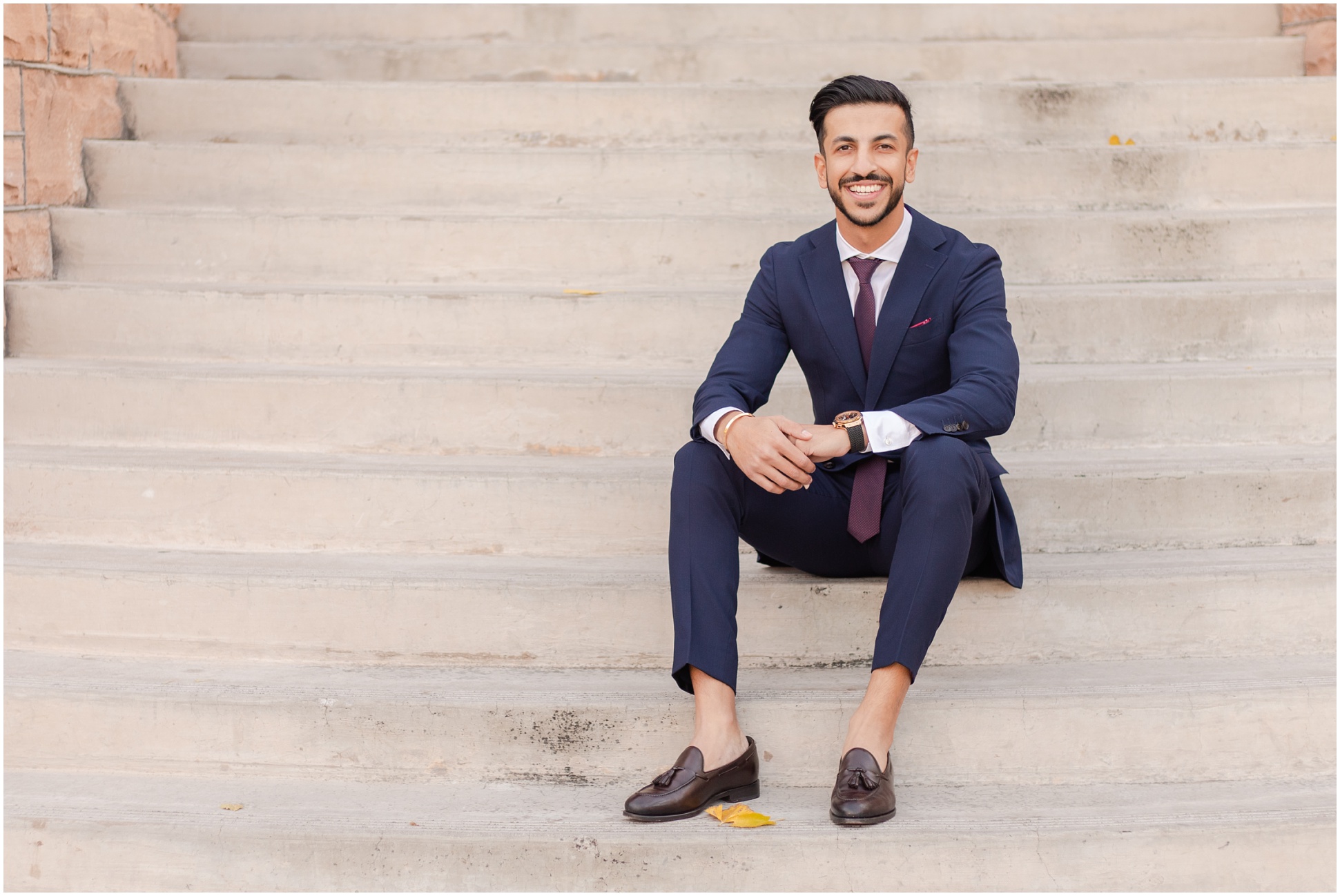 ASU college student sitting on stairs in navy blue suit