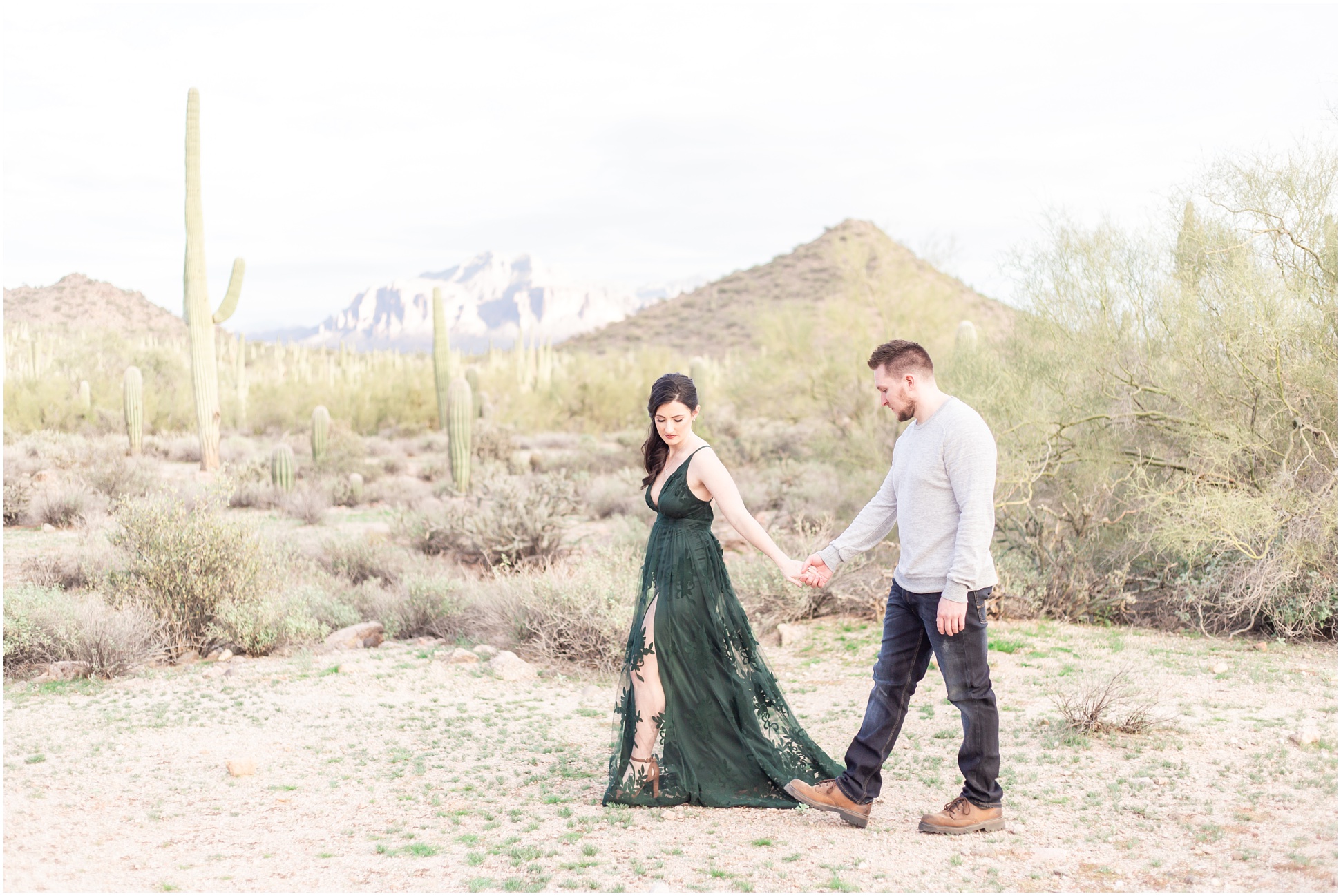 couple in dress attire strolling through desert