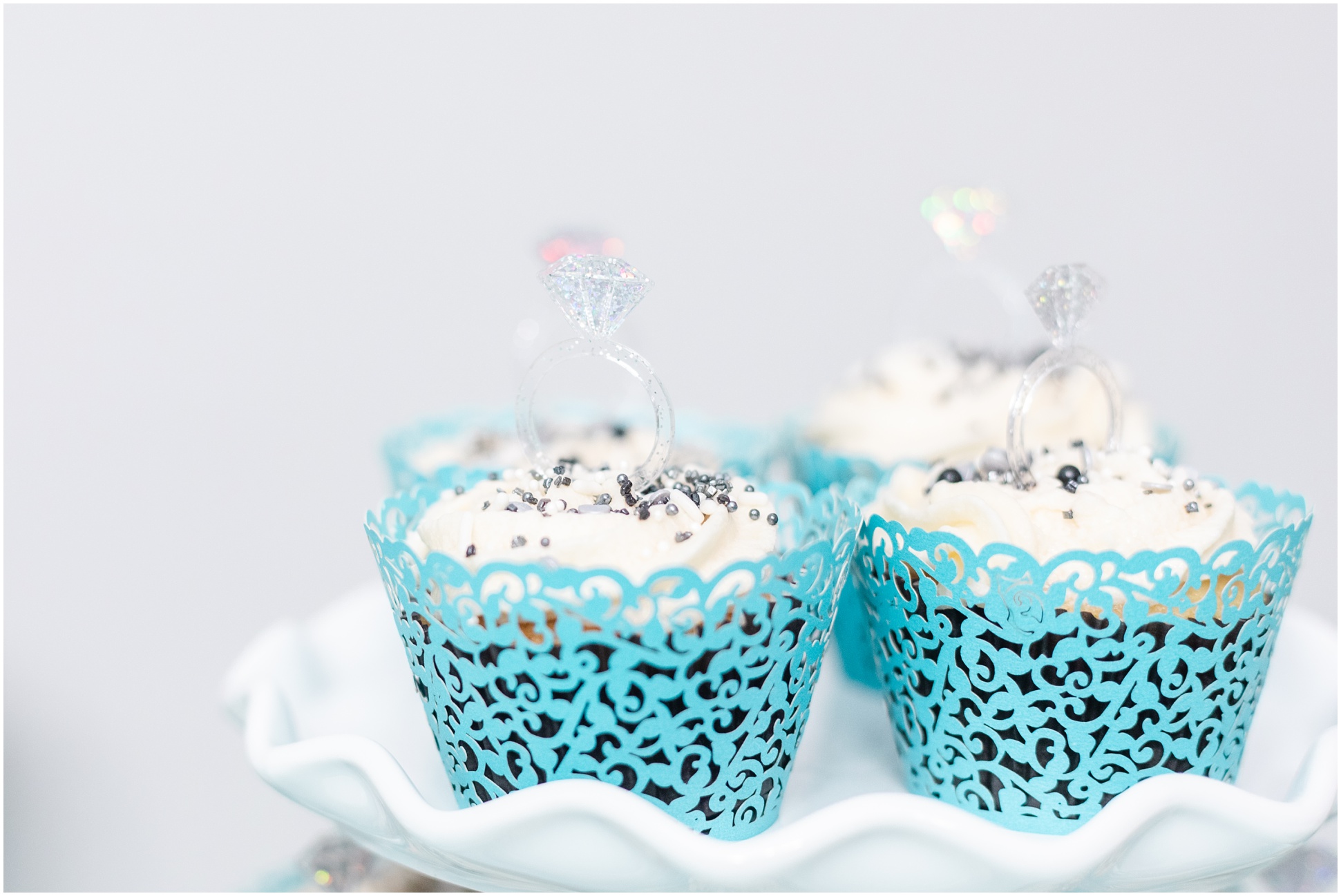 Cupcakes with white frosting and edible pearls in Tifffany blue cupcake wrappers 