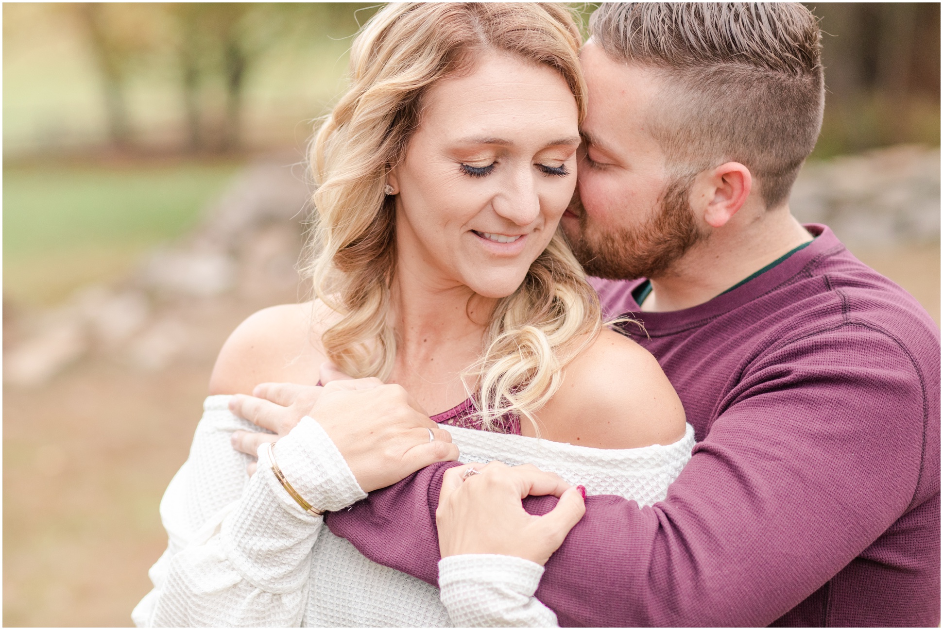 couple snuggling in together during engagement session