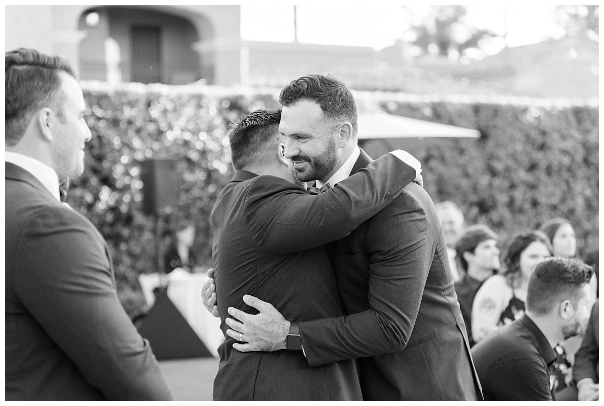 groom and groomsmen hugging