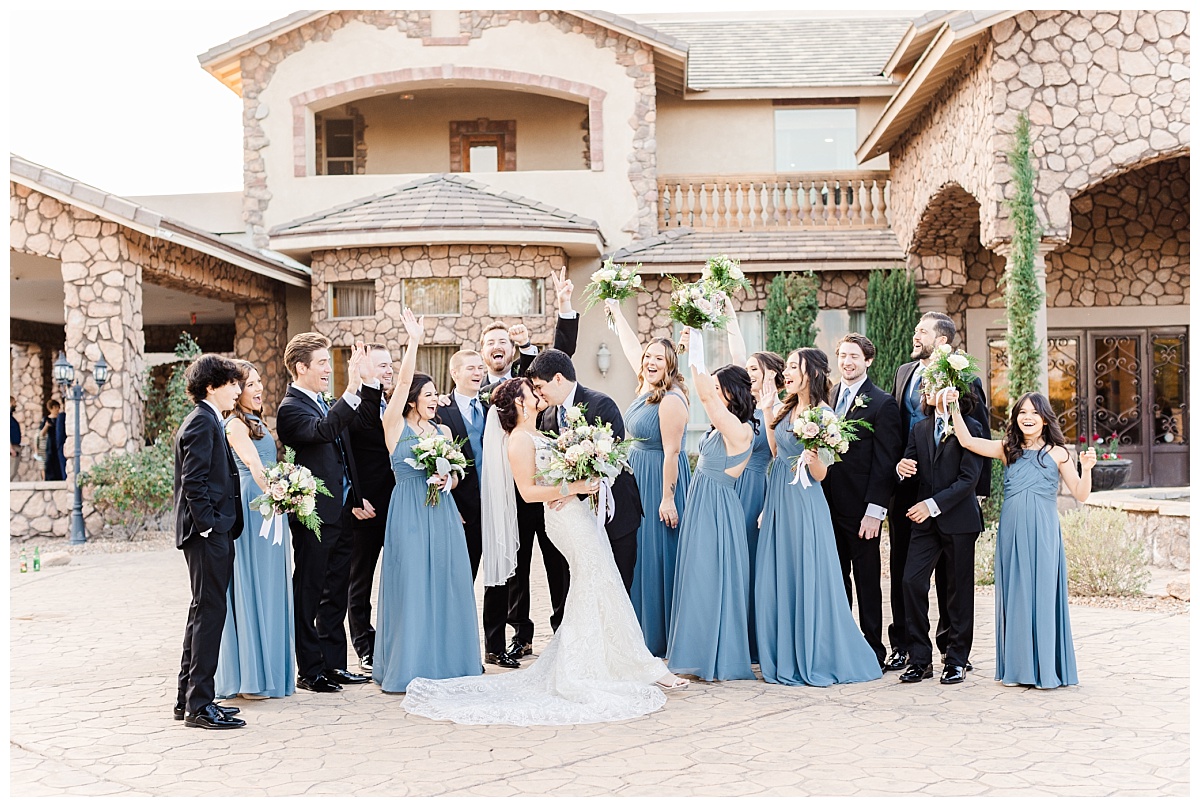 Full bridal party cheering as husband and wife kiss!