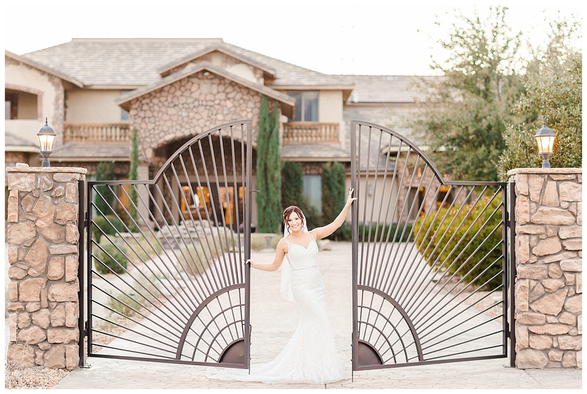 Bride standing at Entrance Gate at Superstition Manor