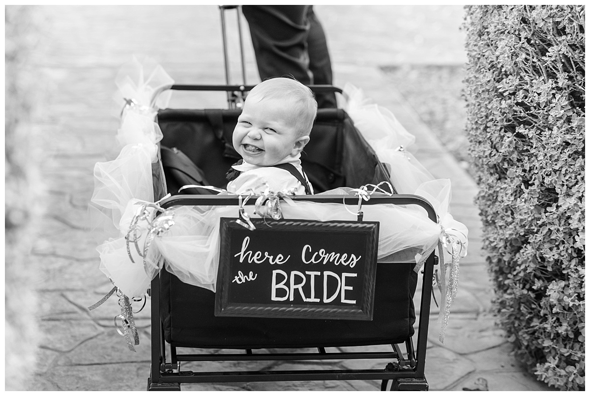 Baby cheesing in a wagon going down the aisle. 