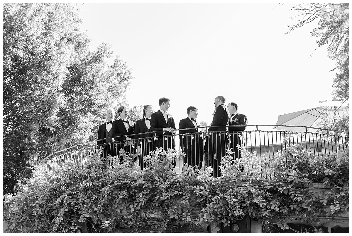 Black and White of Groom and Men on Balcony