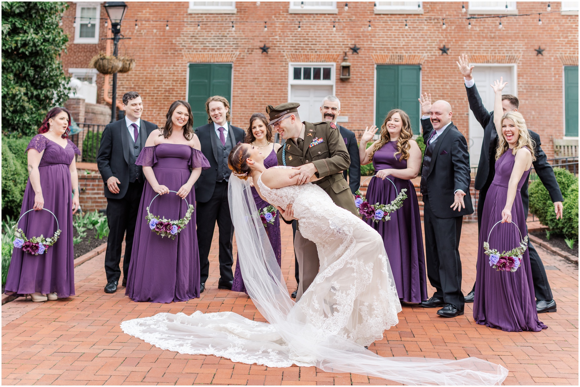 Groom Dipping Bride with Bridal Party behind