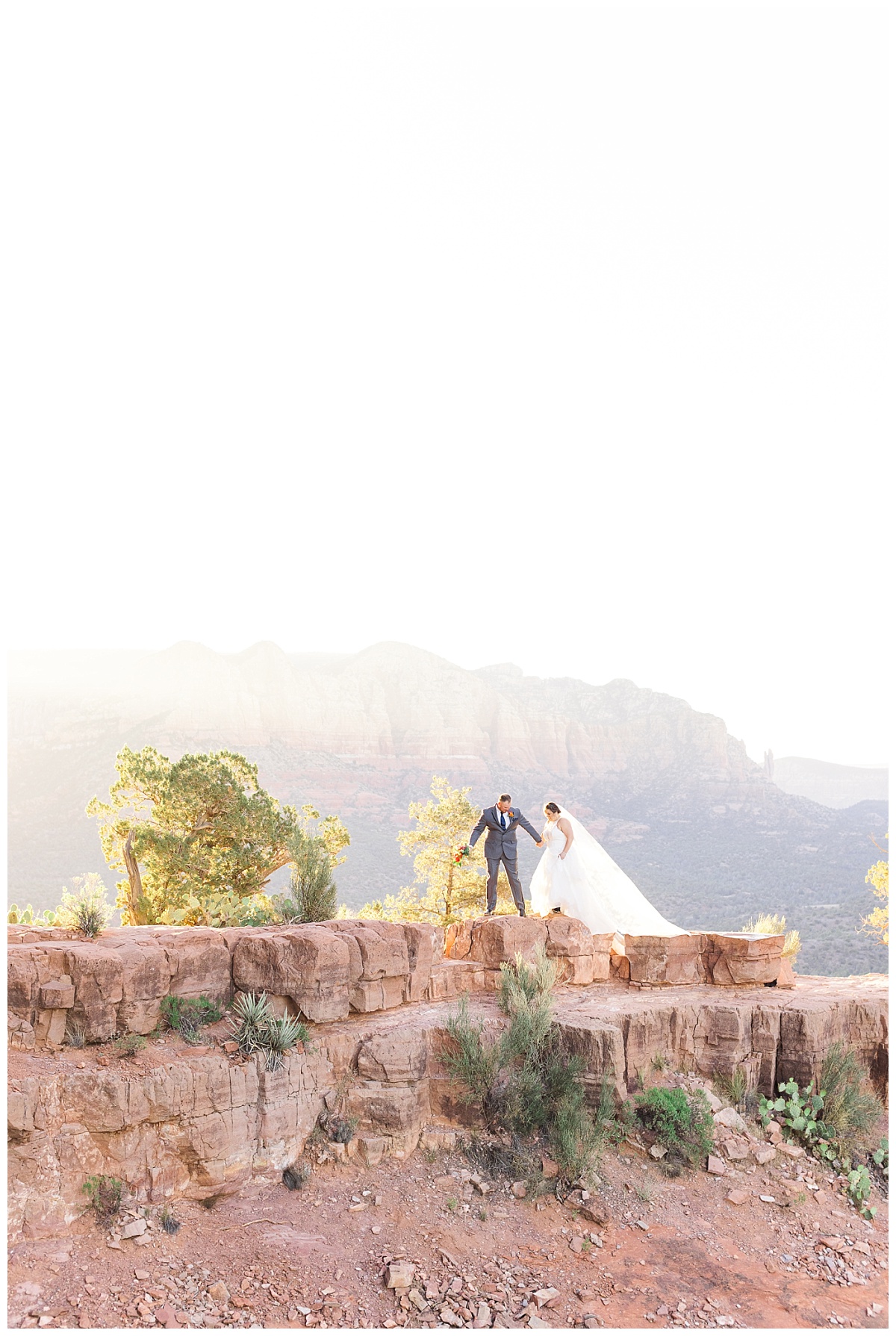 Bride and groom walking the ledge of the end of trail on Cathedral Rock at sunrise