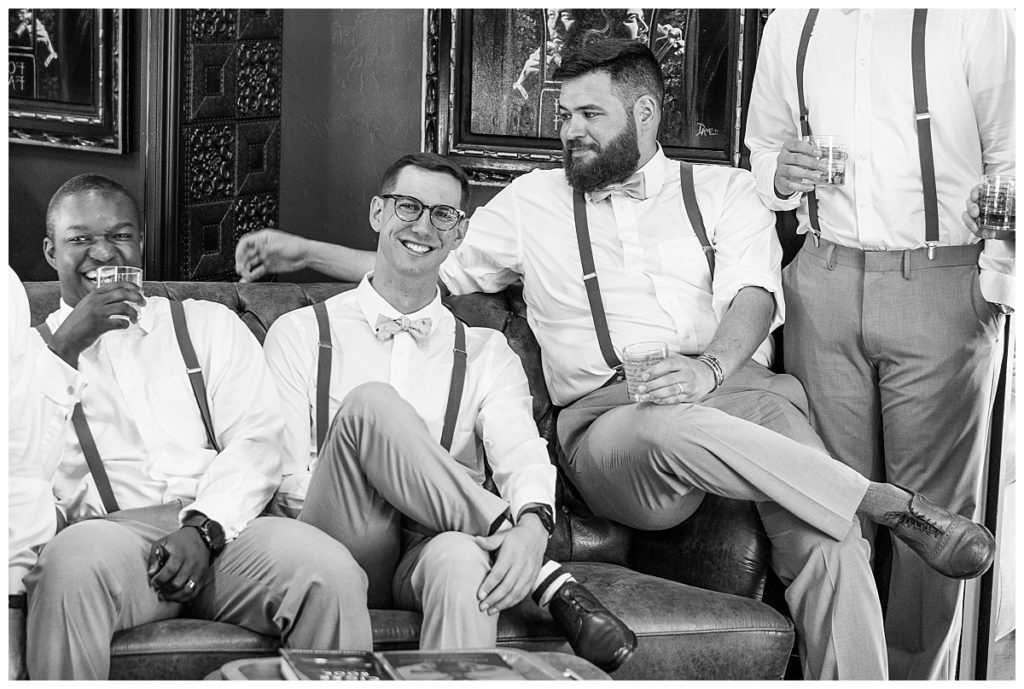 Groomsmen hanging out in the Whiskey room at Founding Fathers
