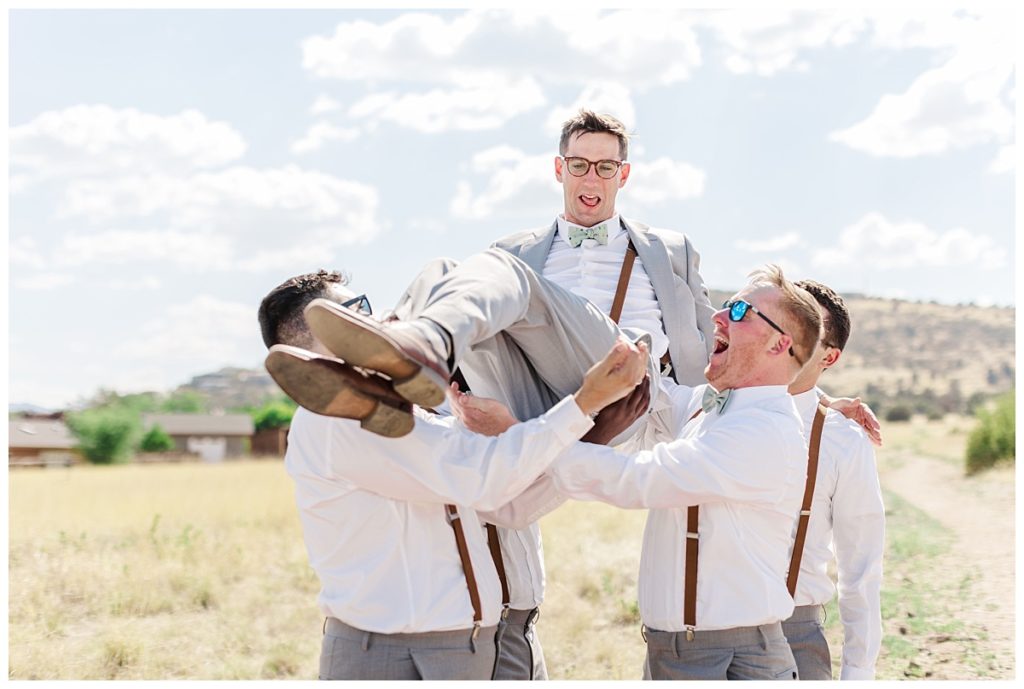 Jake being tossed in the air by his groomsmen