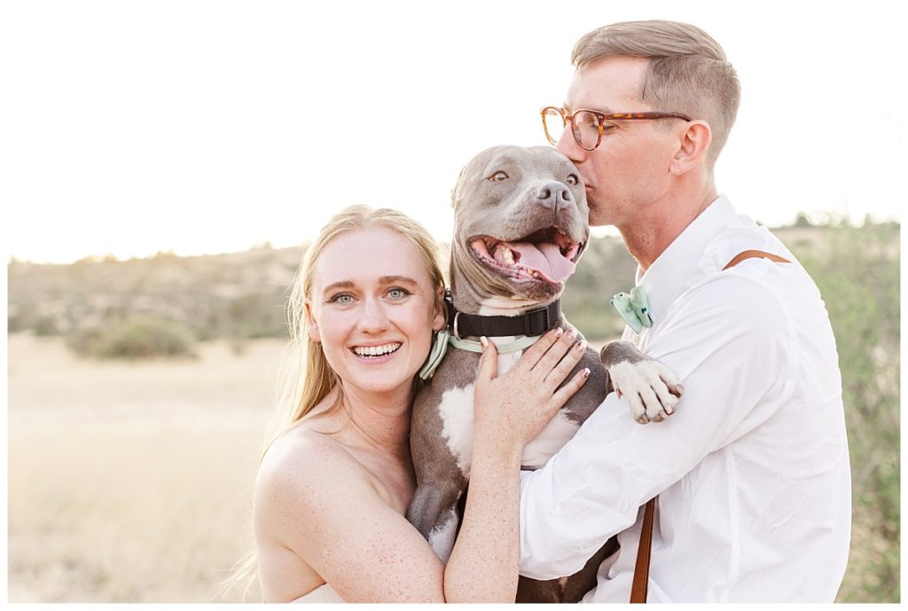Maddy and Jake holding their pocket pit, Blue, on their wedding day