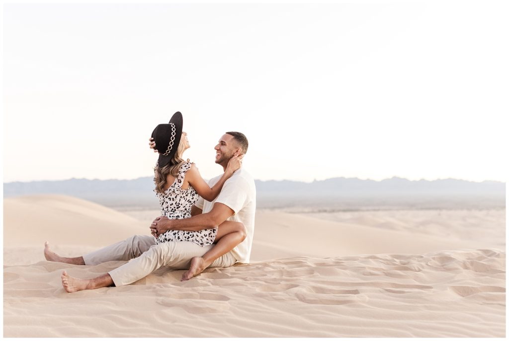 Mary and Jordan giggling as she straddles him at Glamis Sand Dunes.