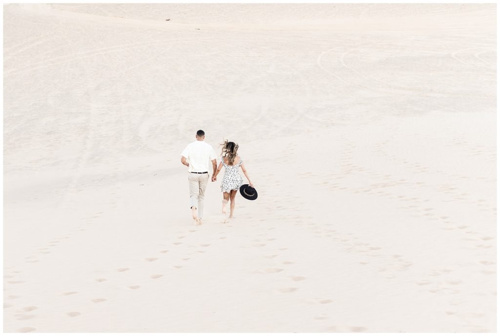 Jordan and Mary running through the dunes to change into their second outfit