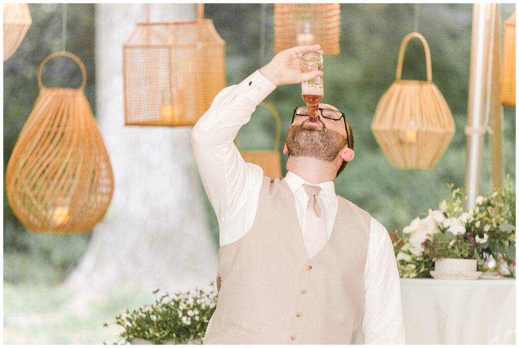Groom chugging his drink after getting "iced" by his groomsmen