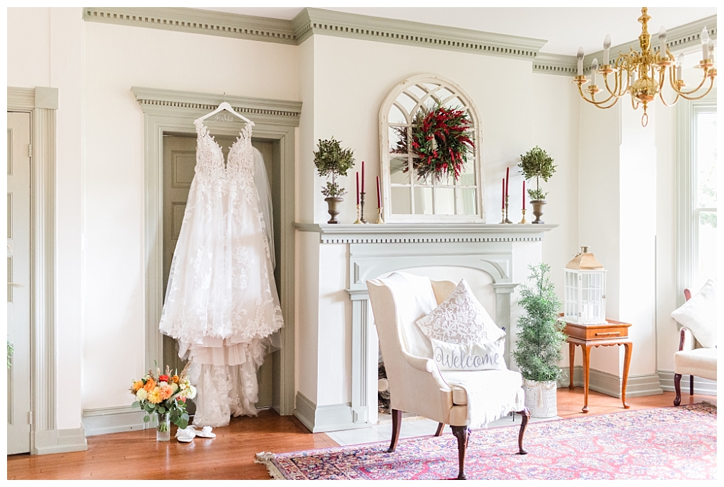 Wide shot of Julia's romantic lace wedding dress against the backdrop of the estate's bridal suite at The Stone Mill Inn, York, PA.